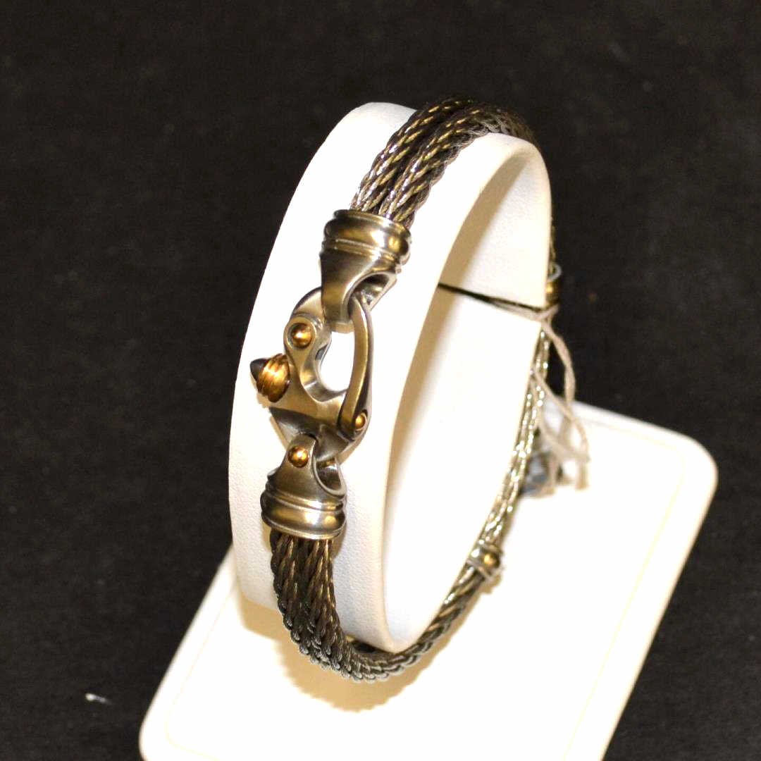 Titanium Cable Bracelet: Titanium cable bracelet with double cable design, 7mm in width, 2 1/2" inside diameter with gold accents. 18.8gm