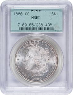 PCGS MS-65 1880-CC Morgan Dollar: Satiny and lustrous with a uniform pale golden glow. Nice! In an old-style PCGS green label holder with plastic frame.