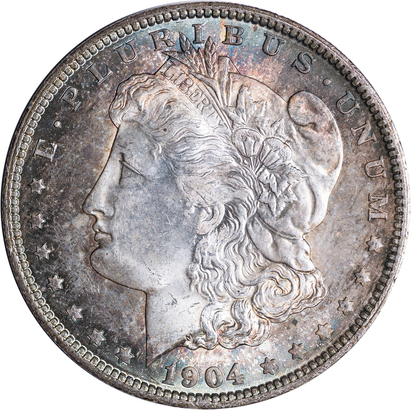 MS-64 Toned 1904-O Morgan Dollar: Intense gold and blue peripheries frame brilliant and lustrous centers.