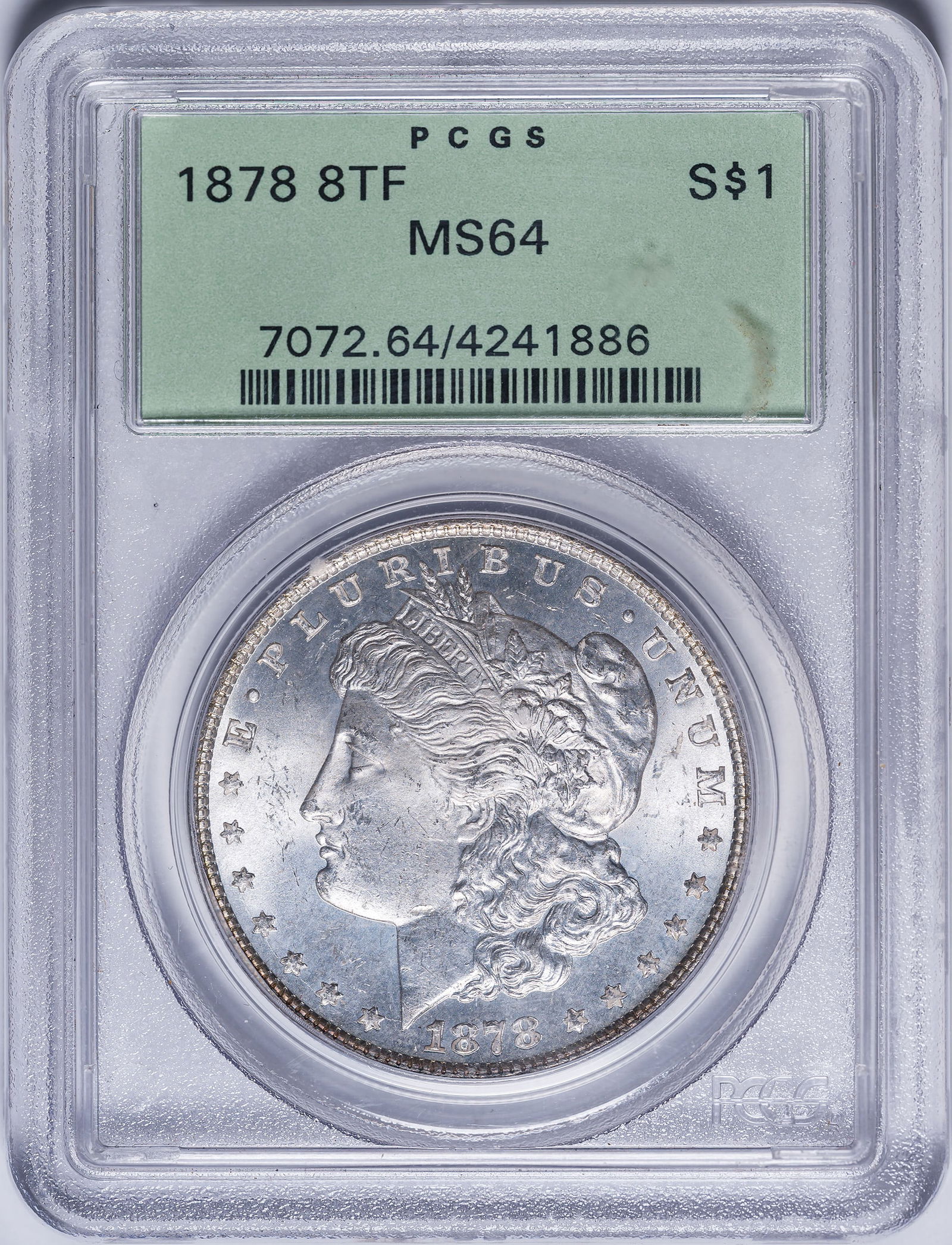 PCGS MS-64 1878 8TF Morgan Dollar: Brilliant and lustrous with a faint champagne-gold glow. In an old-style green label PCGS holder with plastic frame.