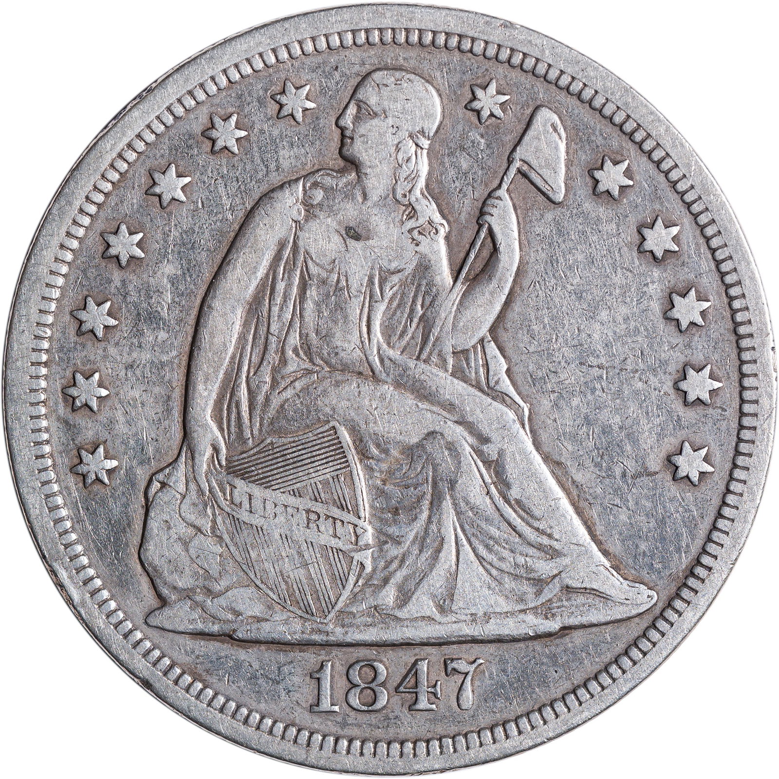 VF-20 1847 Seated Dollar: Shows a light rim bruise at about 8:00 on the reverse.