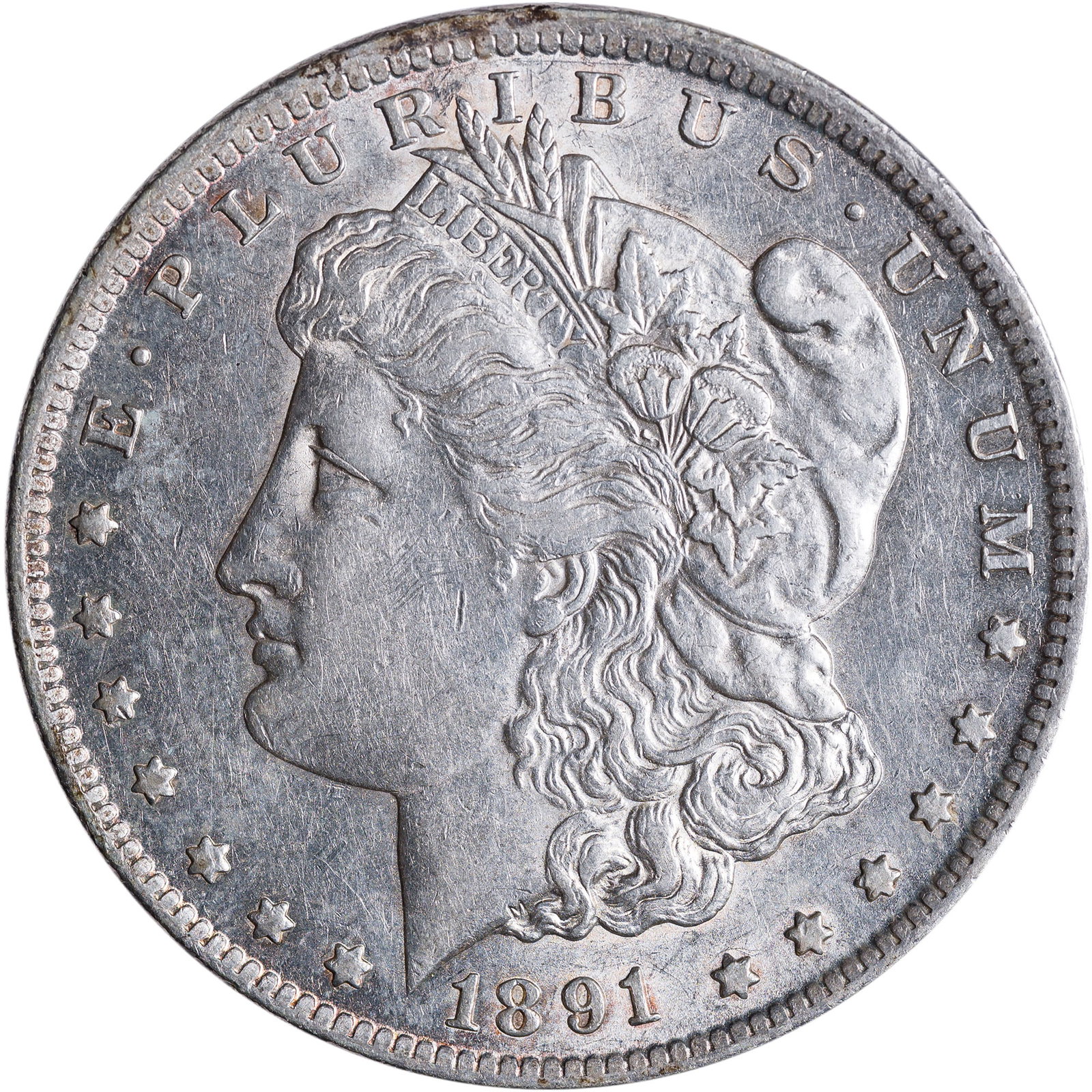 AU-50 1891-CC Morgan Dollar: Lustrous with a pale champagne-gold sheen throughout. Tiny reverse scratches near mintmark.