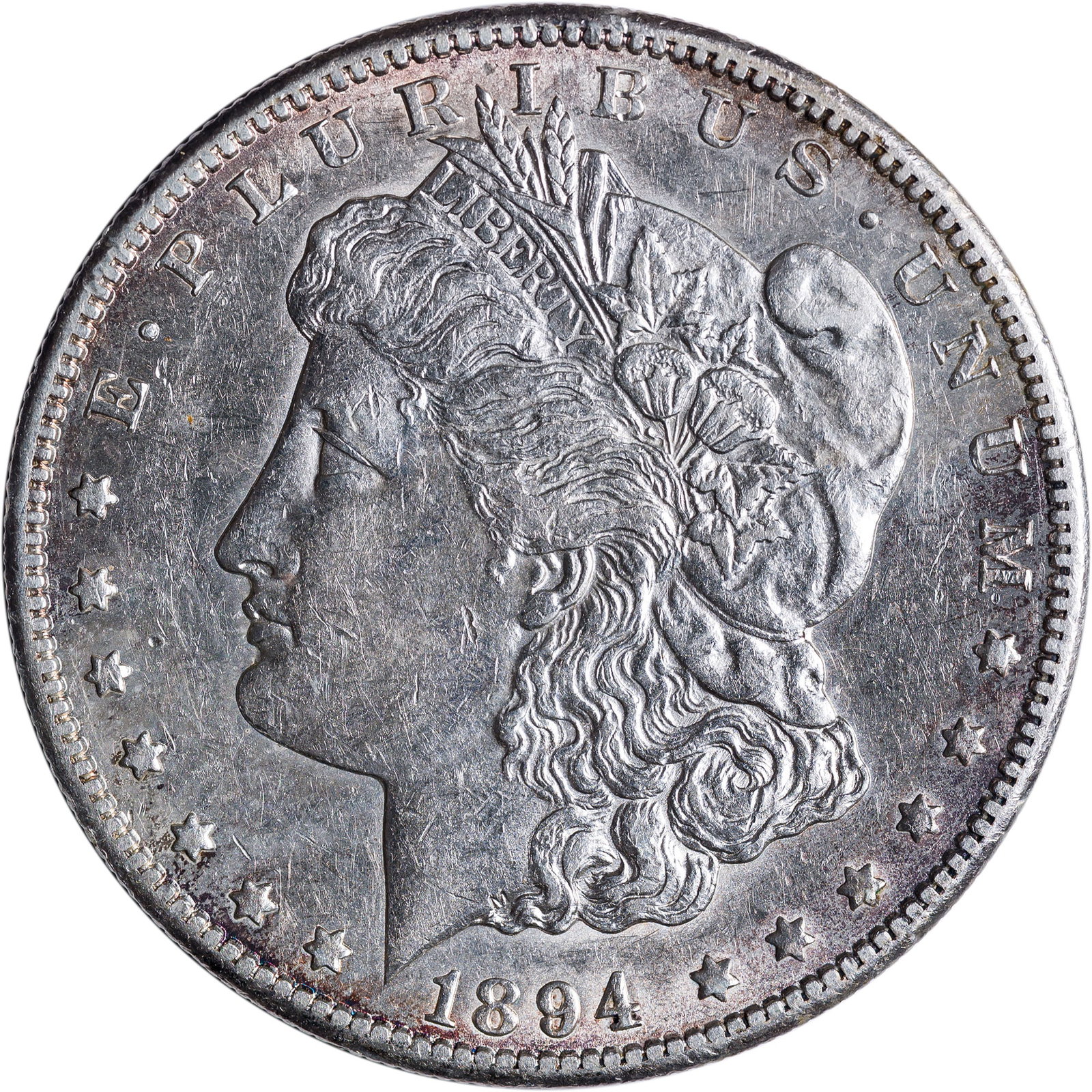 AU-50+ 1894-S Morgan Dollar: Largely brilliant and lustrous, with golden iridescence blossoming at the rims.