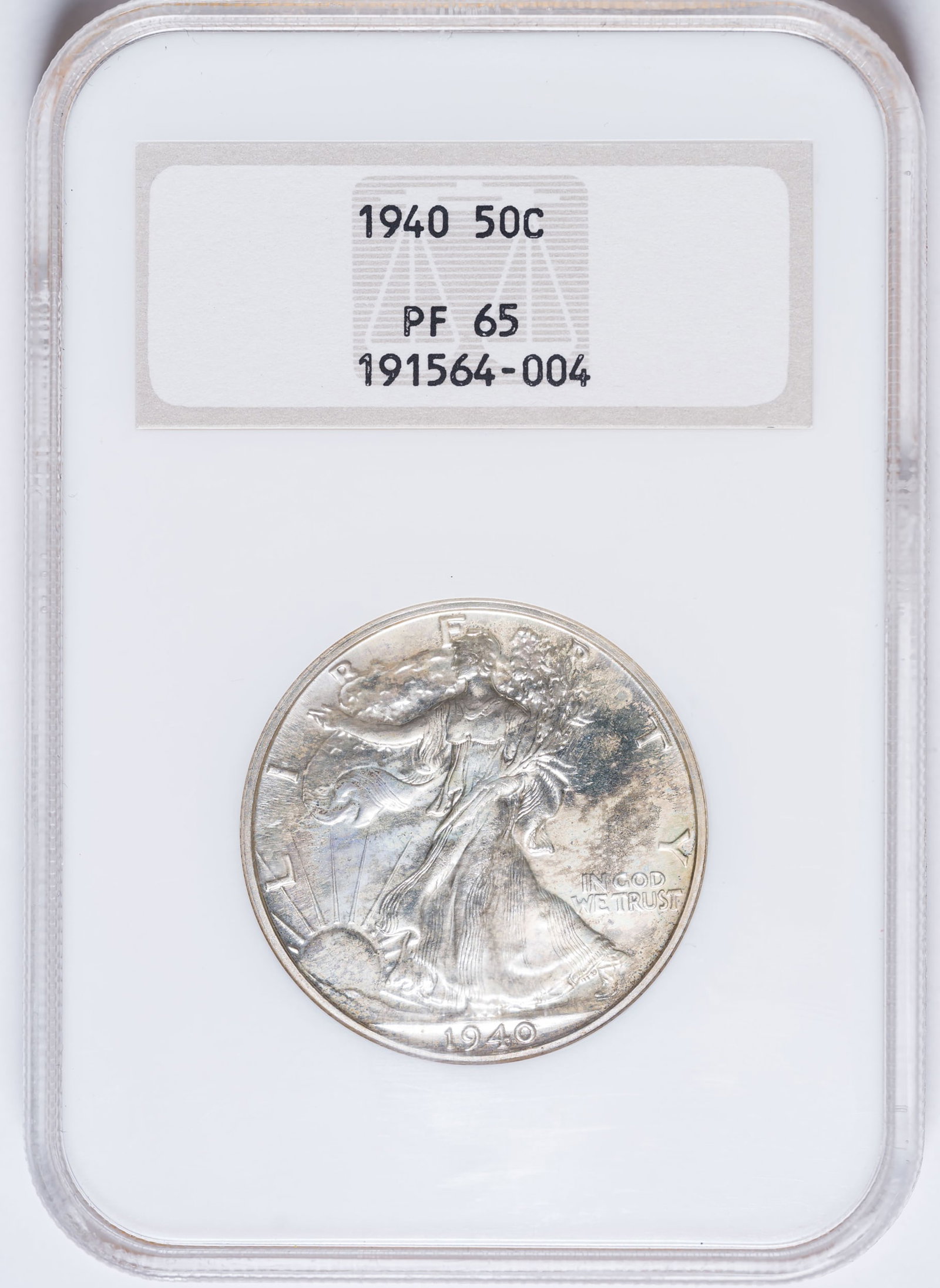 NGC Proof-65 1940 Half Dollar: Fully brilliant and reflective, with splashes of pale golden toning here and there. In an old-style NGC "Fatty" holder.