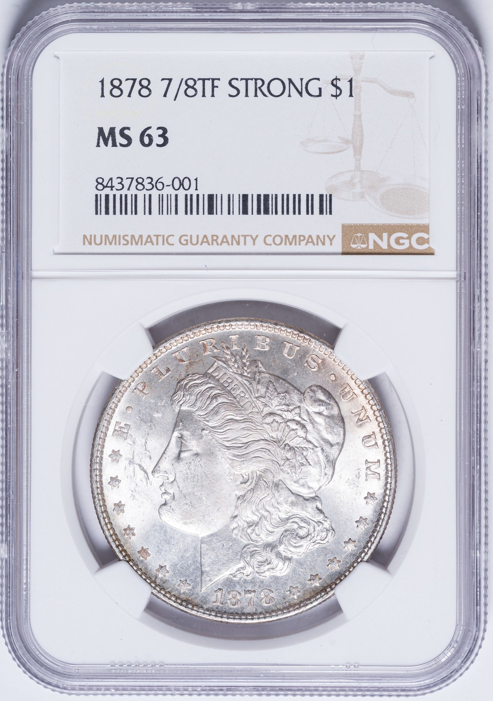 NGC MS-63 1878 7/8TF Morgan Dollar: Strong. Fully five of the underlying eight tail feathers visible; the "Weak" variety shows two or three underlying feathers at best. Bright and lustrous with a hint of pale golden toning at the rims.
