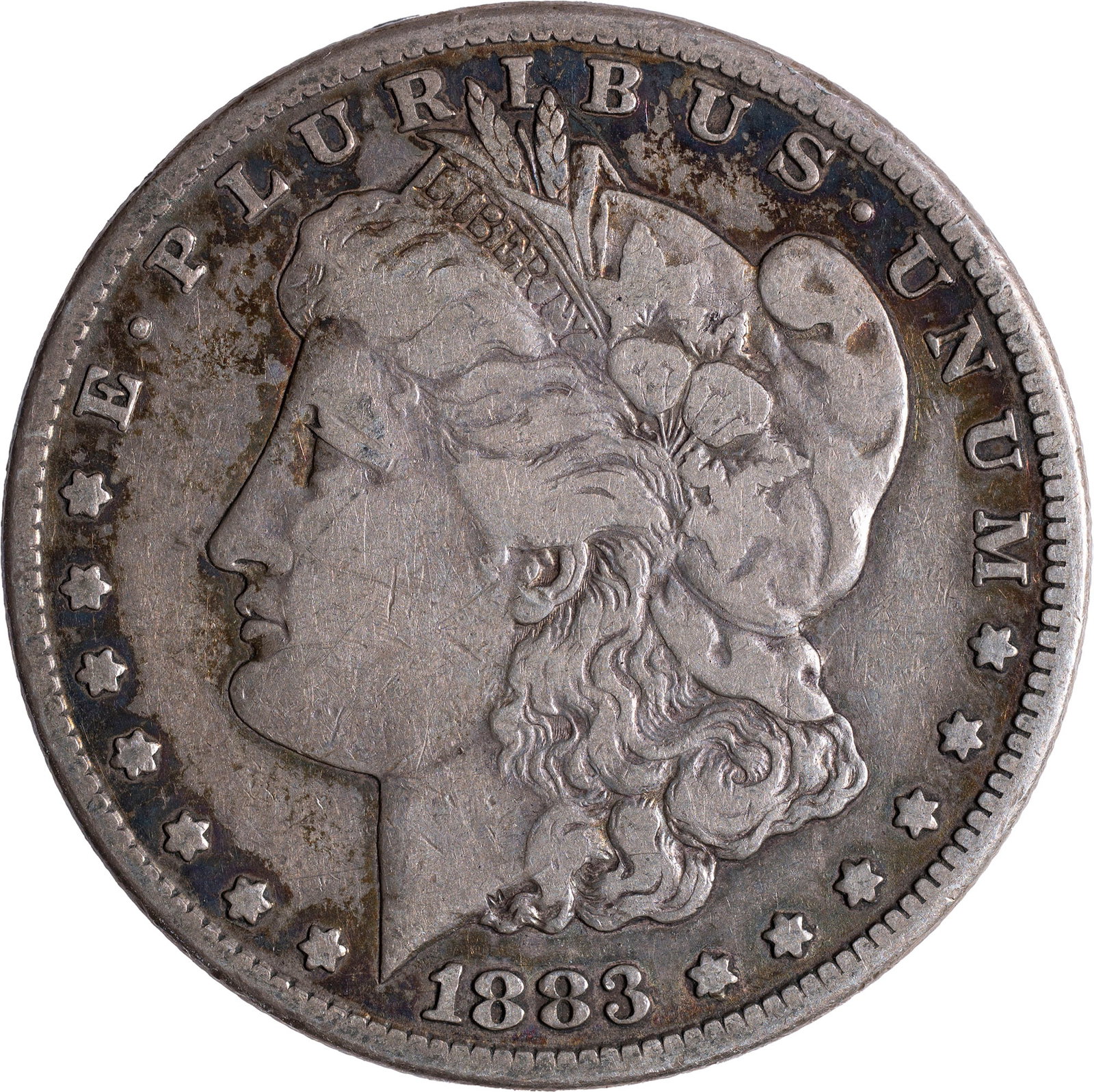 VF-20 1883-CC Morgan Dollar: Silver-gray with deeper highlights.