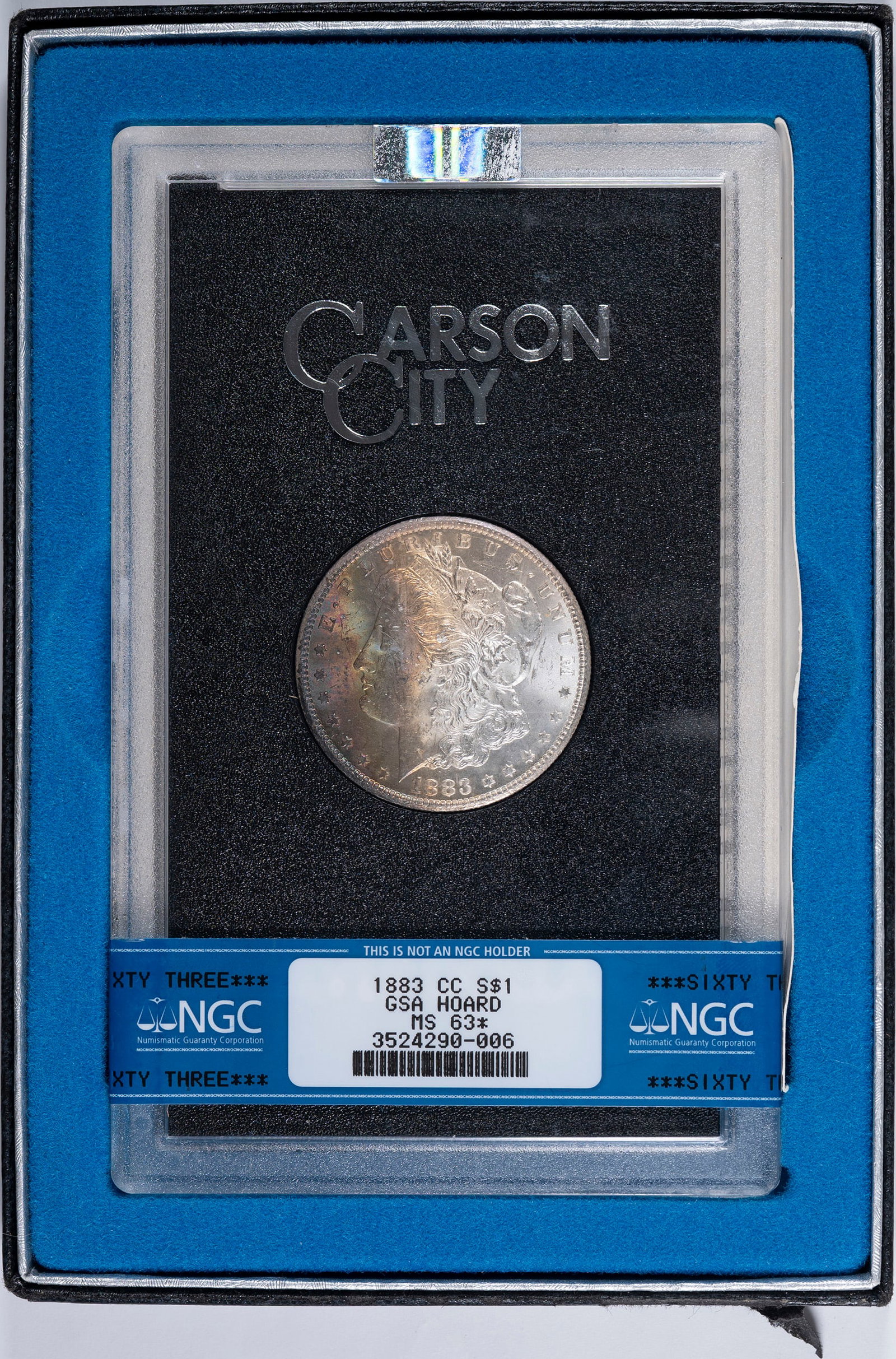 NGC MS-63* 1883-CC GSA Morgan Dollar: Most of the left side of the obverse is covered in a beautiful rainbow tone, which accounts for the star designation on the label. Housed in an NGC banded GSA holder.
