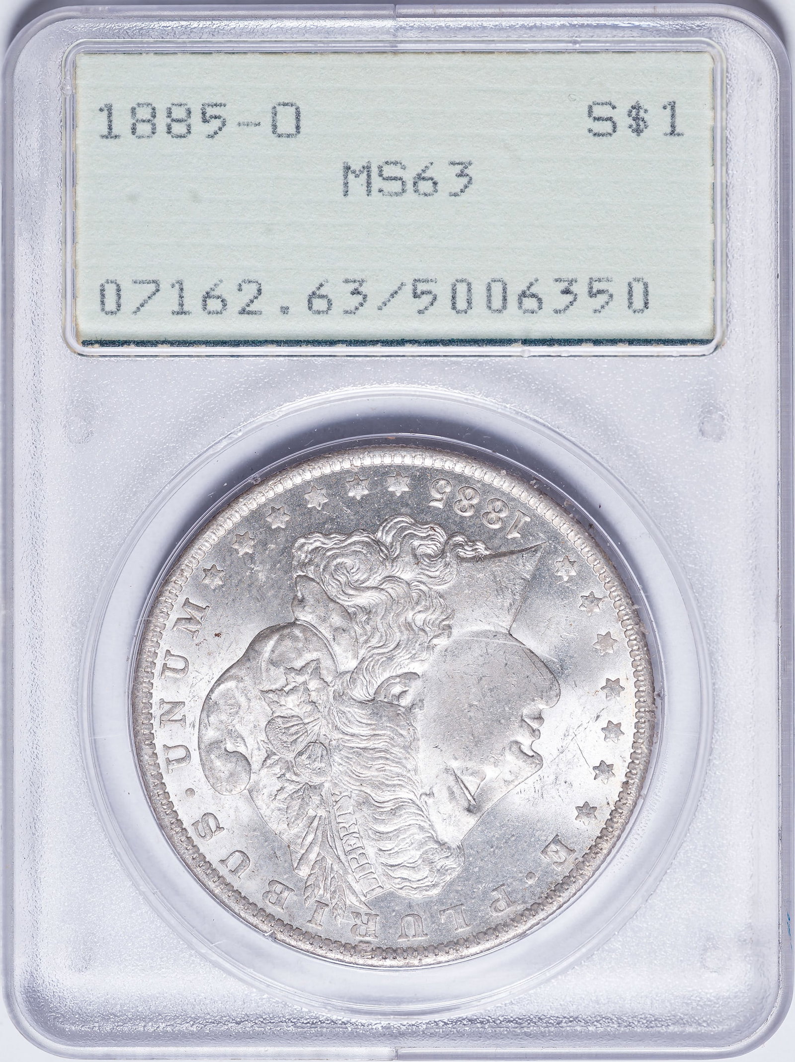 PCGS MS-63 1885-O Morgan Dollar: Frosty, satiny, sharp, and brilliant. In an old-style green label PCGS "Rattler" holder.