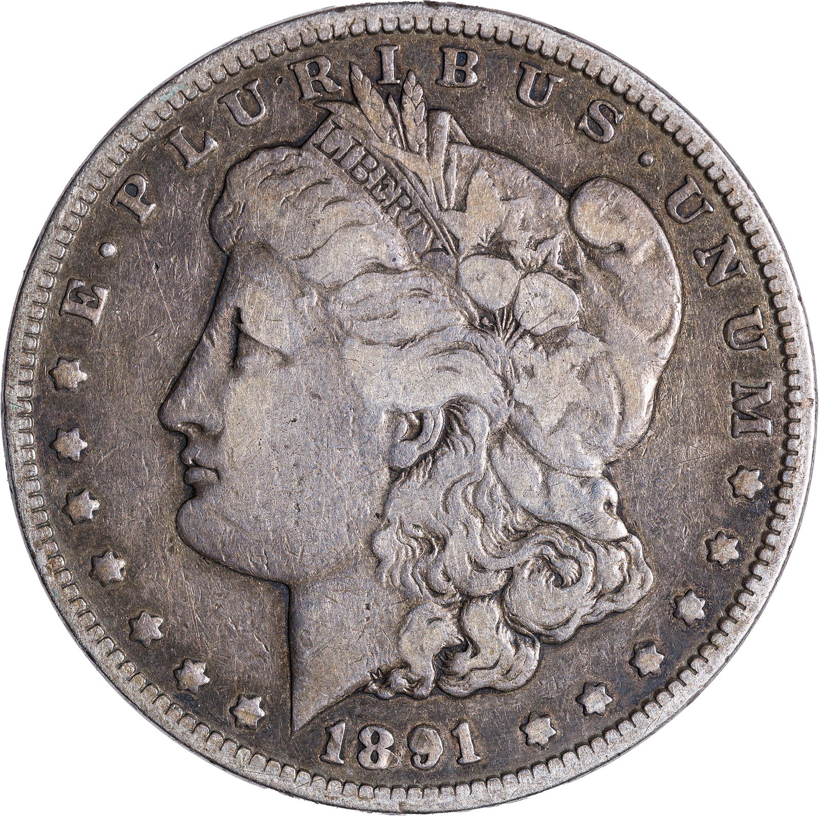Fine-12 1891-CC Morgan Dollar: Smoky slate highlights guard the protected areas of this golden-gray Morgan dollar.