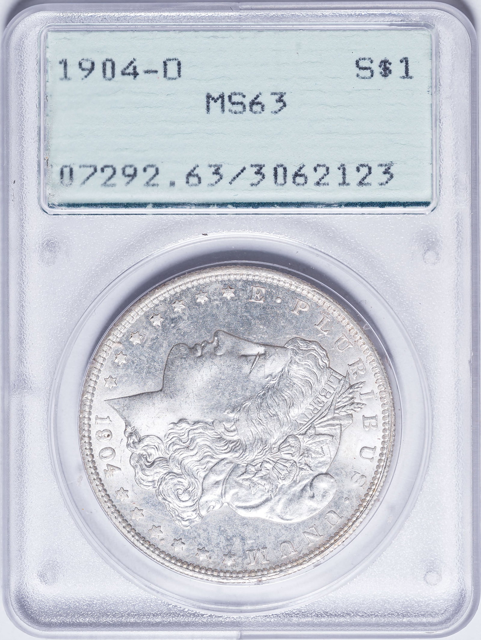 PCGS MS-63 1904-O Morgan Dollar: Satiny, brilliant, and lustrous. In an old-style green label PCGS "Rattler" holder.