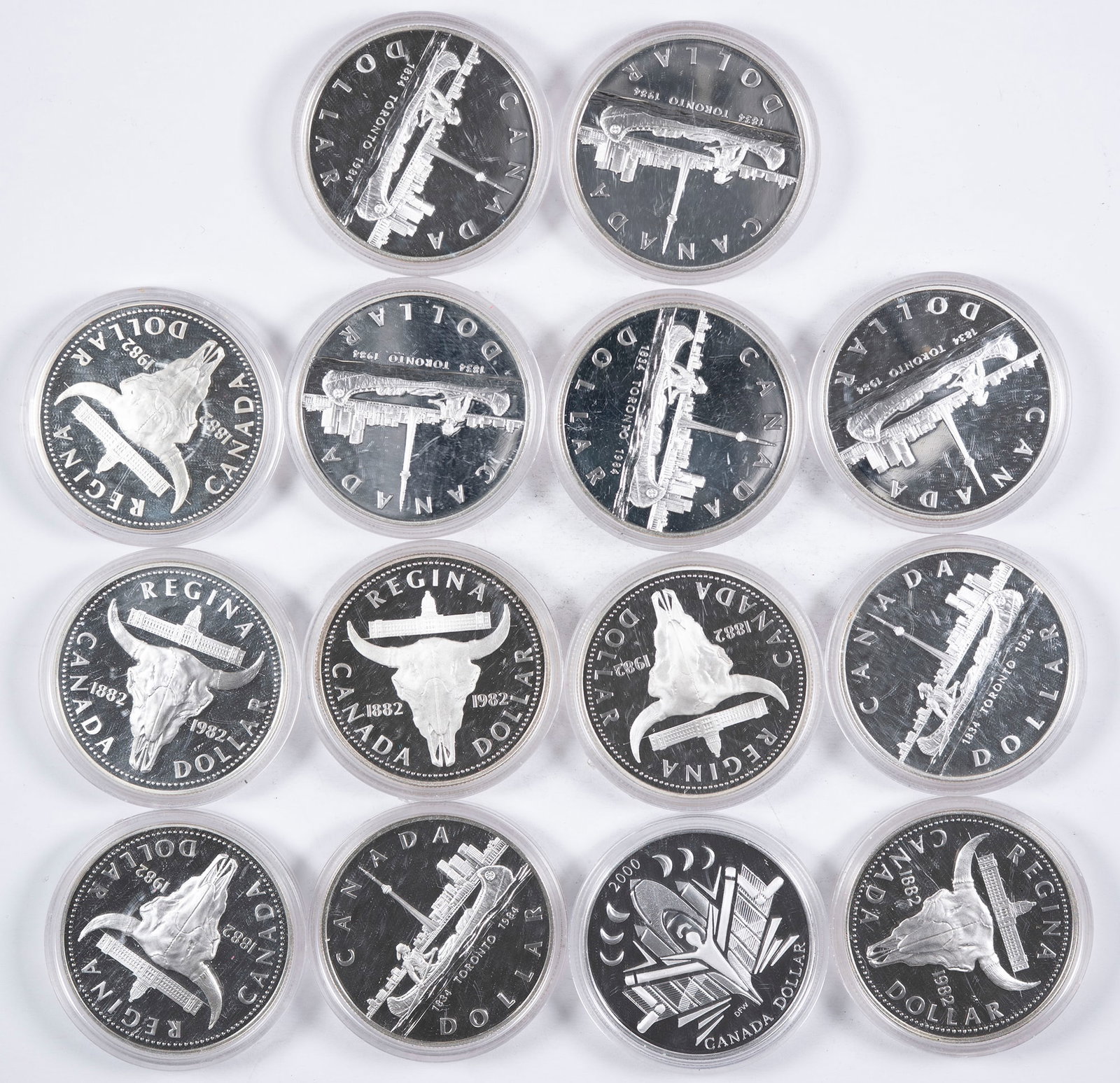 Canada. 14 Coin Silver Dollar Lot: Includes (7) 1982, (6) 1984 and (1) 2000. The earlier coins were each struck in .500 fine silver and contain .375 ounces pure silver while the 2000 issue was struck in sterling silver and contains