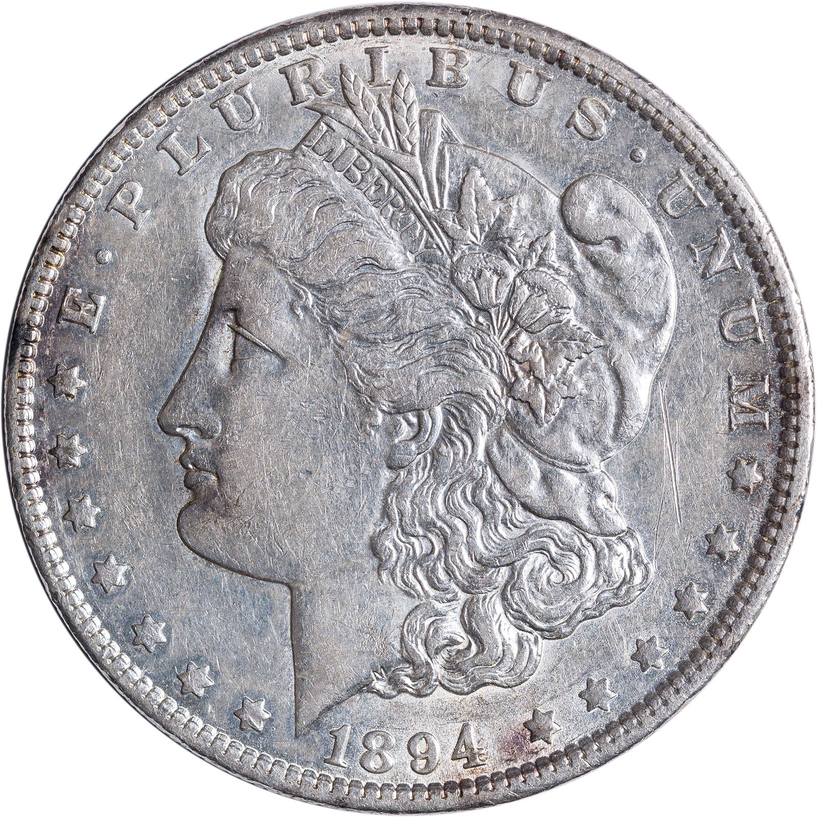 AU-50+ 1894-O Morgan Dollar: Lustrous with some obverse and reverse toning spots. Plenty of mint bloom resides in the protected areas.