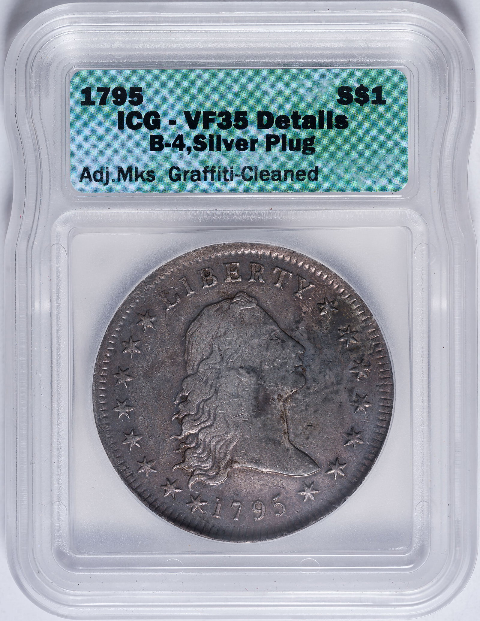 ICG VF-35 Details 1795 Silver Plug Dollar: Flowing Hair. Adjustment Marks, Cleaned, Graffiti. Long since retoned in rich shades of varied gray, and not nearly as horrid as the qualifiers sound. Silver plug plainly visible; the plugs were