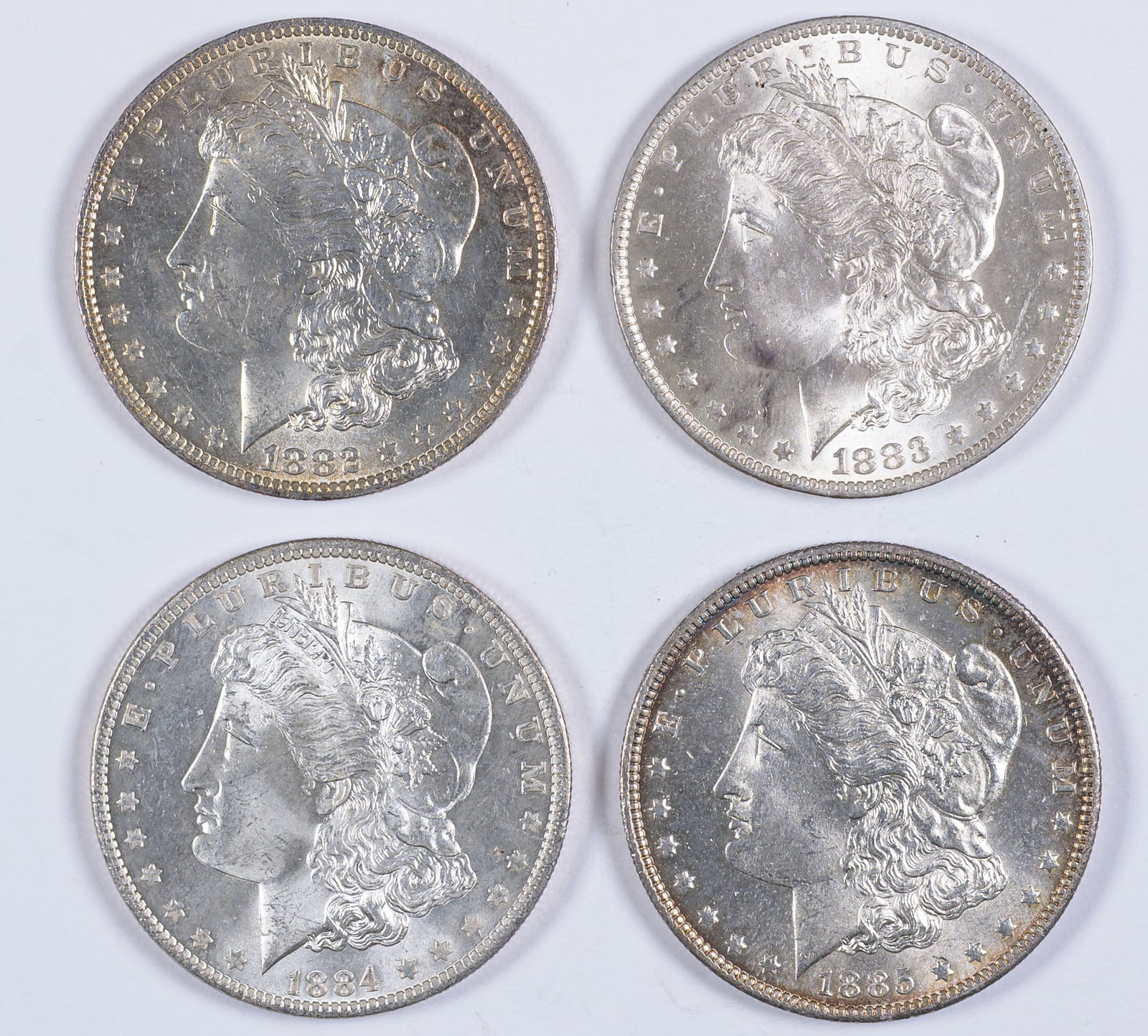 Choice BU-63 "O" Mint Morgan Dollar Quartet: Includes 1882-O, 1883-O, 1884-O & 1885-O. Each grades MS-63 with most showing some light tone. (Total: 4 pcs)
