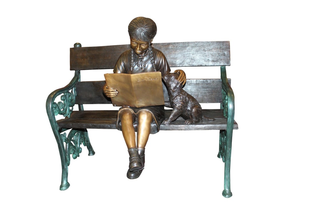 Girl sitting with her dog on a bench, reading Bronze Statue - 27" x 39" x 32"H: Magnificent large size bronze of a girl sitting with her dog on a bench outside and reading a book. The joy of youth, lost in a book and putting thoughts to paper, will make your landscape come alive.