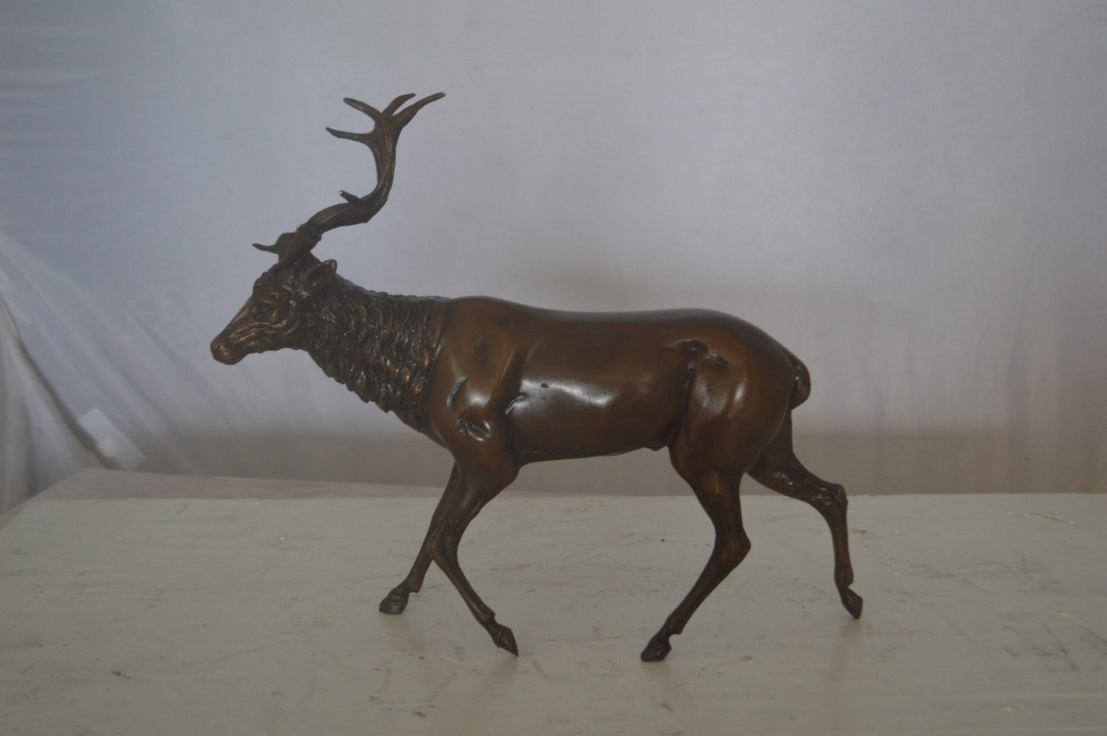 Running Deer Bronze Statue - Size: 15"L x 4"W x 13"H.: This beautiful bronze sculpture of a running deer, will impress any visitors to your home. The elegance of the deer running proudly and majestically in contrast to the sweet innocence of it's fawn wil