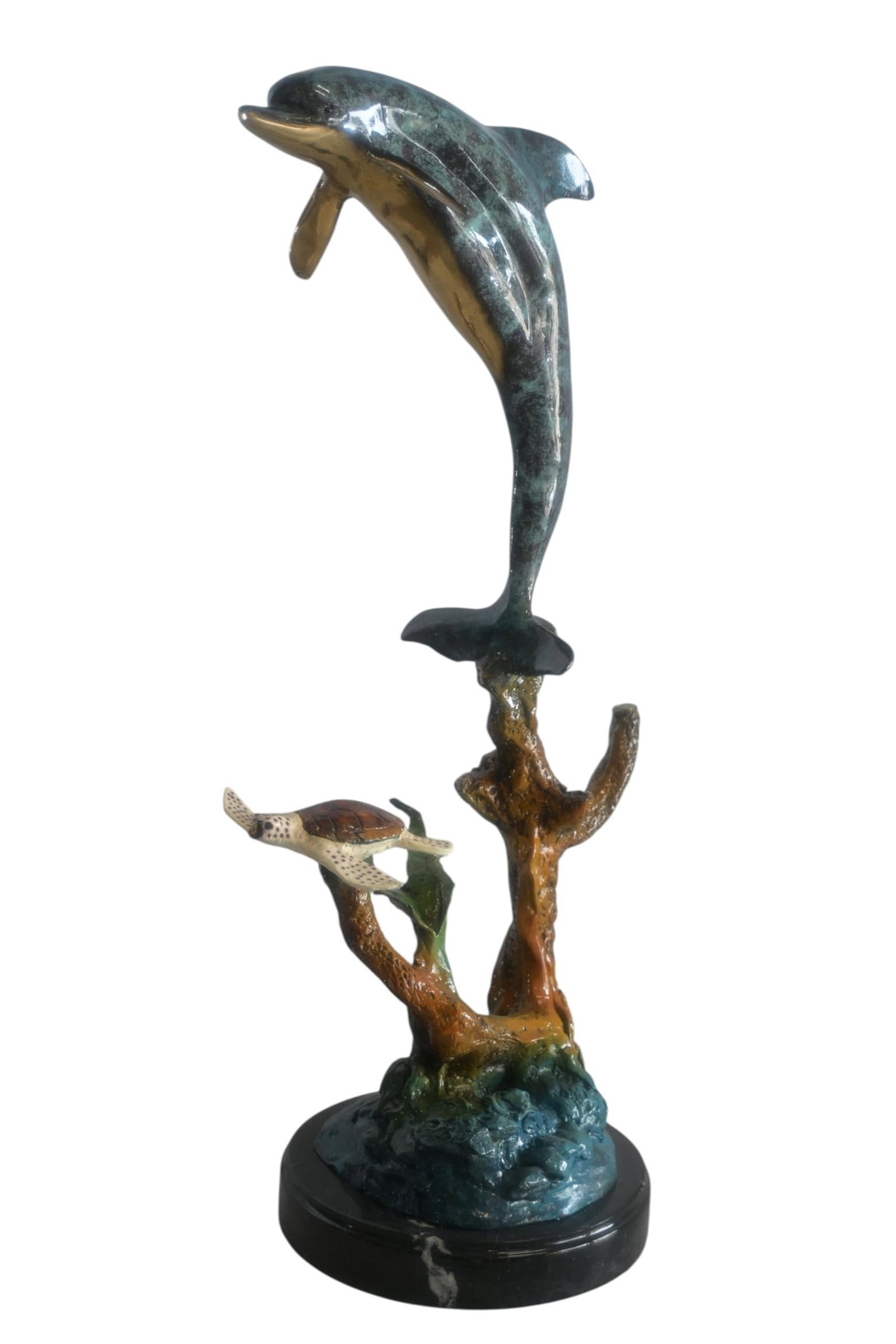 Bronze Leaping Dolphin and Sea Turtle Sculpture Marble Base 12"x9"x27"H: This stunning bronze sculpture features a dolphin leaping powerfully above an intricate coral and sea turtle scene below. Finished using a hand-applied enameling technique over bronze the dolphin disp