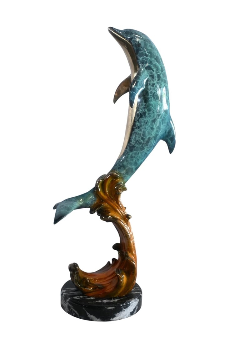 Bronze Leaping Dolphin Sculpture on Wave Base 25"x24"x40"H: This bronze dolphin sculpture is manufactured using the traditional lost wax casting method and captures the animal in a graceful mid leap pose. A vivid turquoise patina covers the body with gold tone