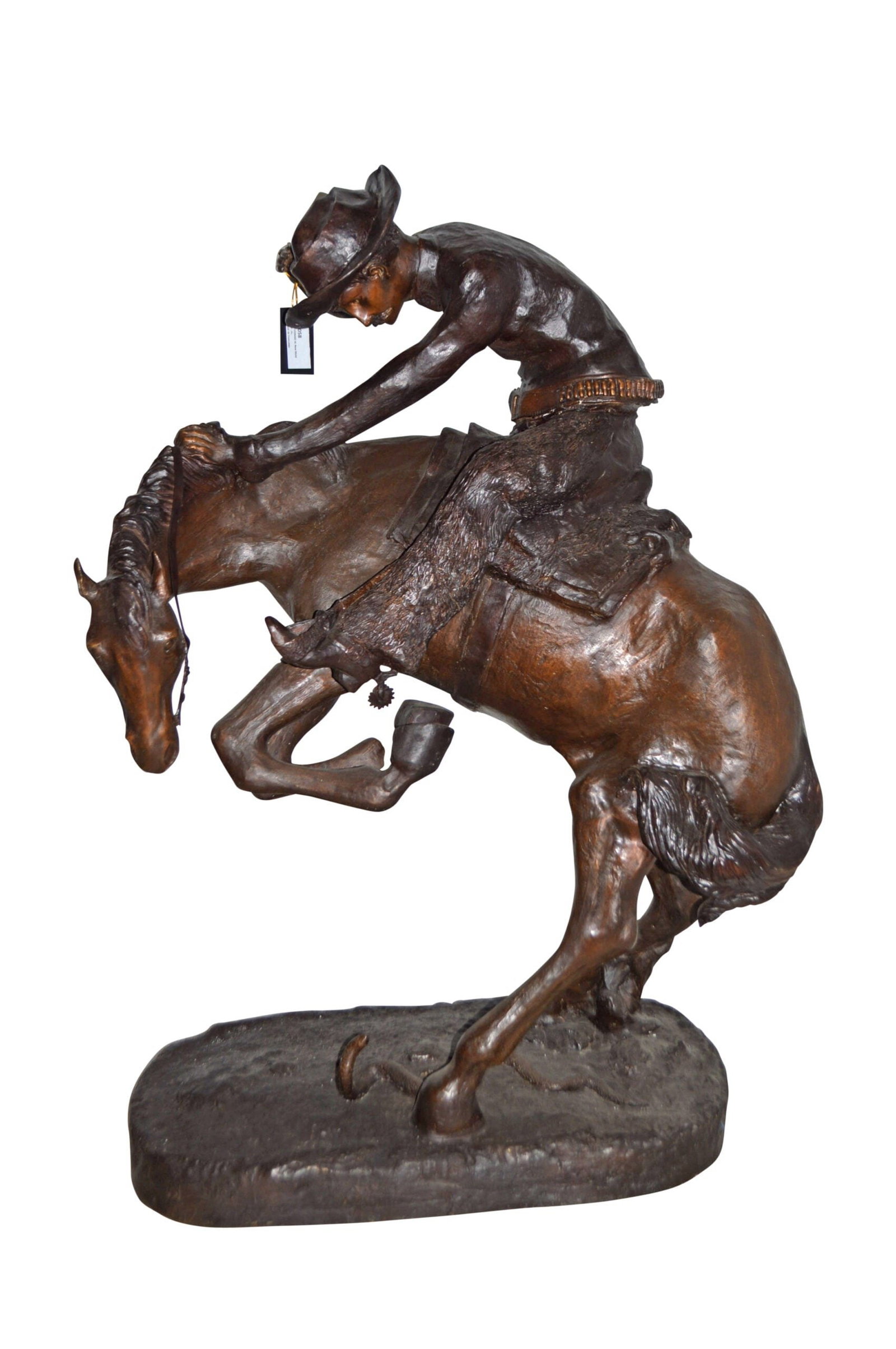 Giant Rattlesnake A Frederic Remington Replica Size: 36" x 30" x 60"H: This bronze statue replicates the well-known piece named "Rattlesnake" by famous sculptor Frederic Remington. In this piece of art, the saddle, hat, and curvature of the man and horse signify immense 