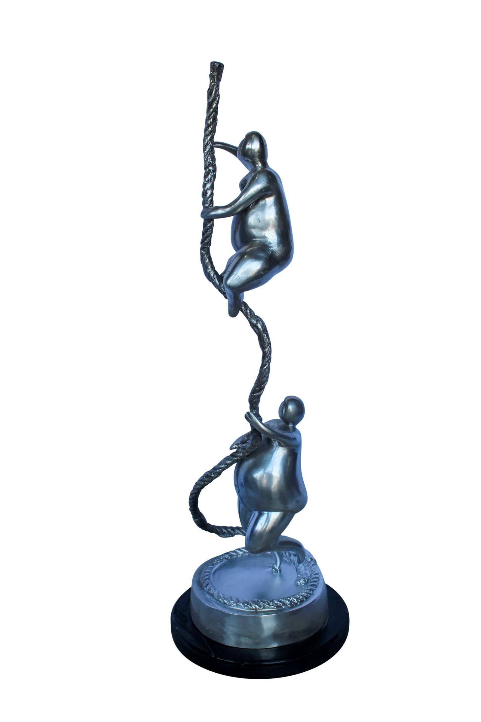 Two Voluptuous Women Climbing a Rope Statue, Silver Finish 10" x 10" x 29"H: Enhance your space with a striking statue of two voluptuous women climbing a rope in a silver finish. Handcrafted and casted using traditional lost wax method this art piece captures the strength and 