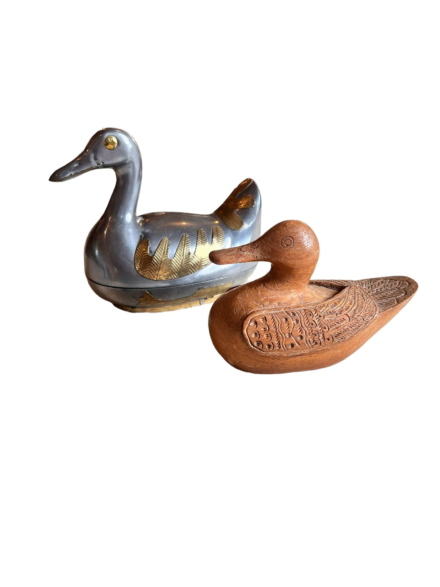 LOT OF 2 AWESOME DUCKS: Lot of 2 awesome ducks. 1 is hand carved wood duck with a secret compartment on the bottom. One is a pewter duck with brass wings and base. Wood duck with secrets measures 5 inches long by 3.5 inches