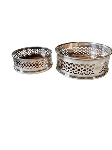 LOT OF 2 ENGLISH SILVER PLATED WINE COASTERS: Lot of 2 silver plated wine bottle coasters from England. Smaller one is 1.5 inches tall by 4 inches wide. Larger one is 5.5 inches wide by 2 inches tall. Wood base in both coaster, larger coaster sho