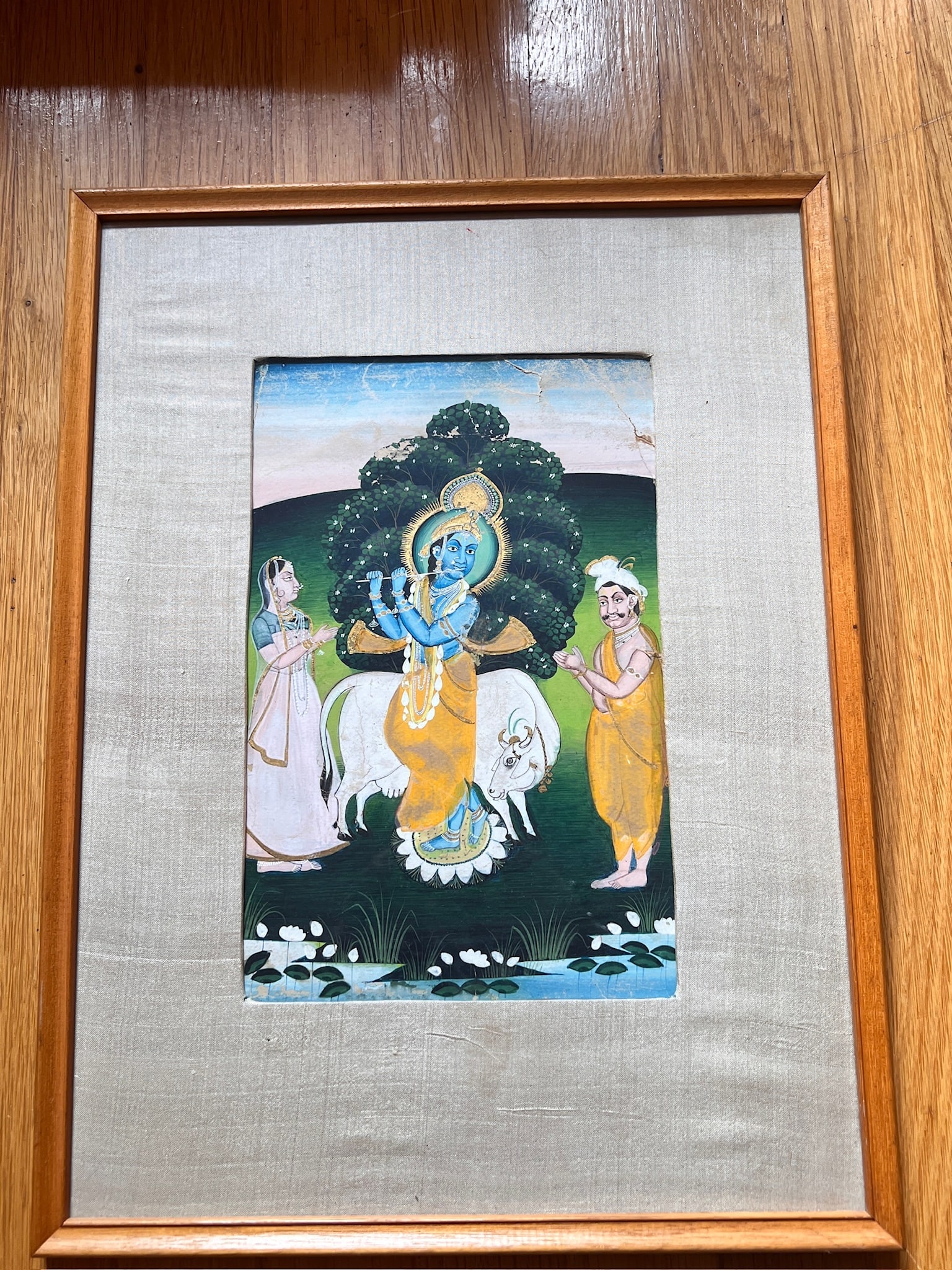 Krishna Painting on Fabric India Hindu: Vintage paining on fabric of Krishna. Wood frame. Measures 16.75 inches long x 12.5 inches wide. damage n the upper right area of the artwork. See photos. Krishna, one of the most widely revered and m