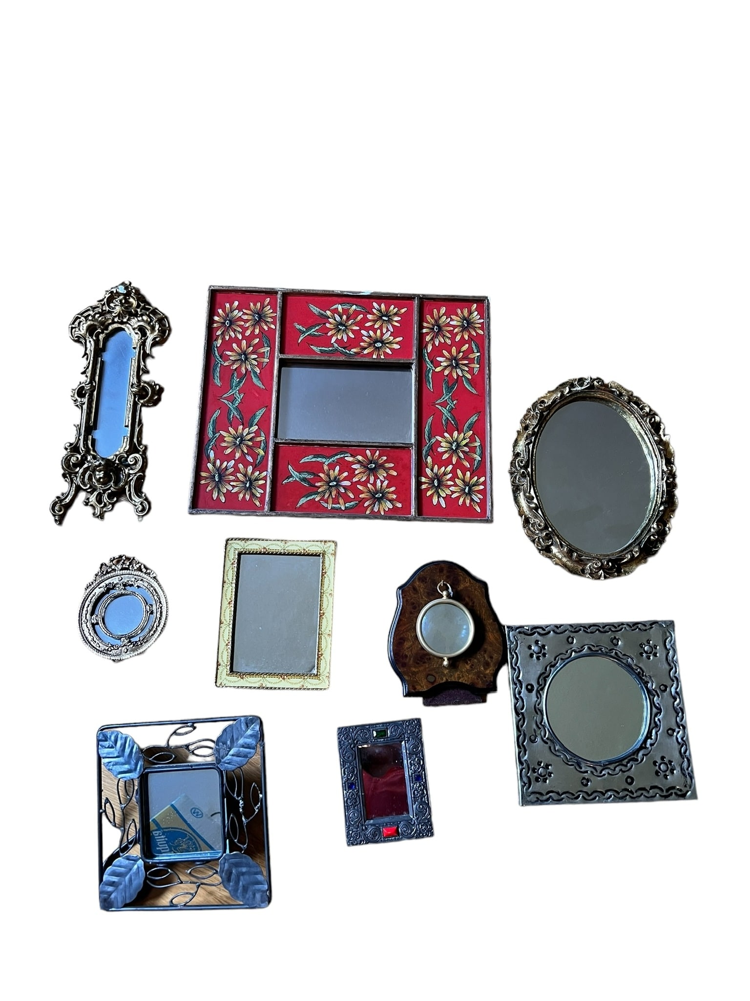Collection of Diminutive Mirrors (9): Collection of diminutive mirrors of varying sizes and styles. 9 mirrors in this lot. Some are metal and older. The largest one measures 11.75 inches long x 10 inches tall. The smallest mirror is a rou