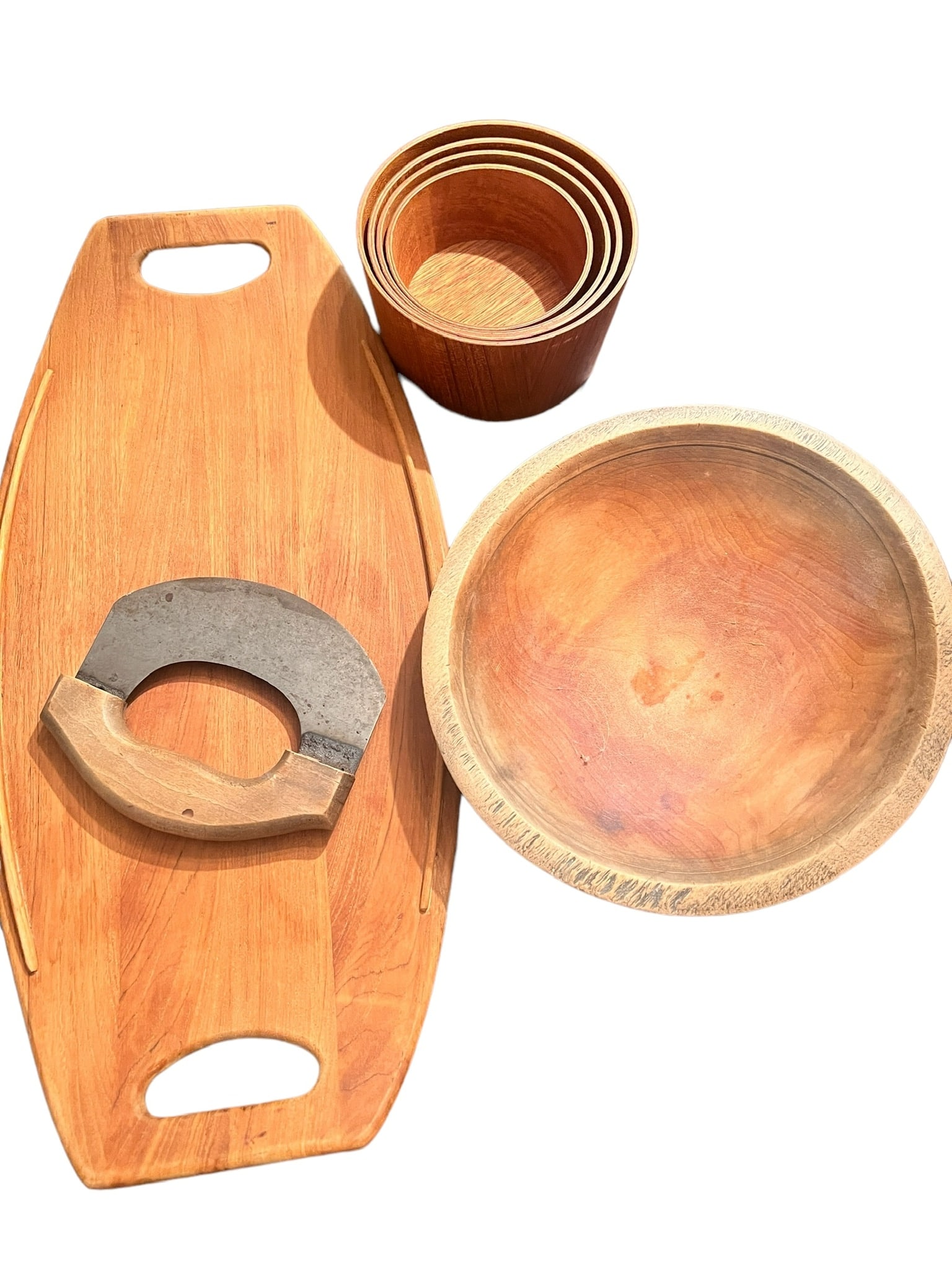 Lot of 4 Wood Serveware Pieces: Four piece wooden lot. Lot includes one set of graduated measures with the largest being 6 inches wide by 3 inches tall, one old wooden bowl 10 inches wide 2 inches tall, one antique chopper, one wood