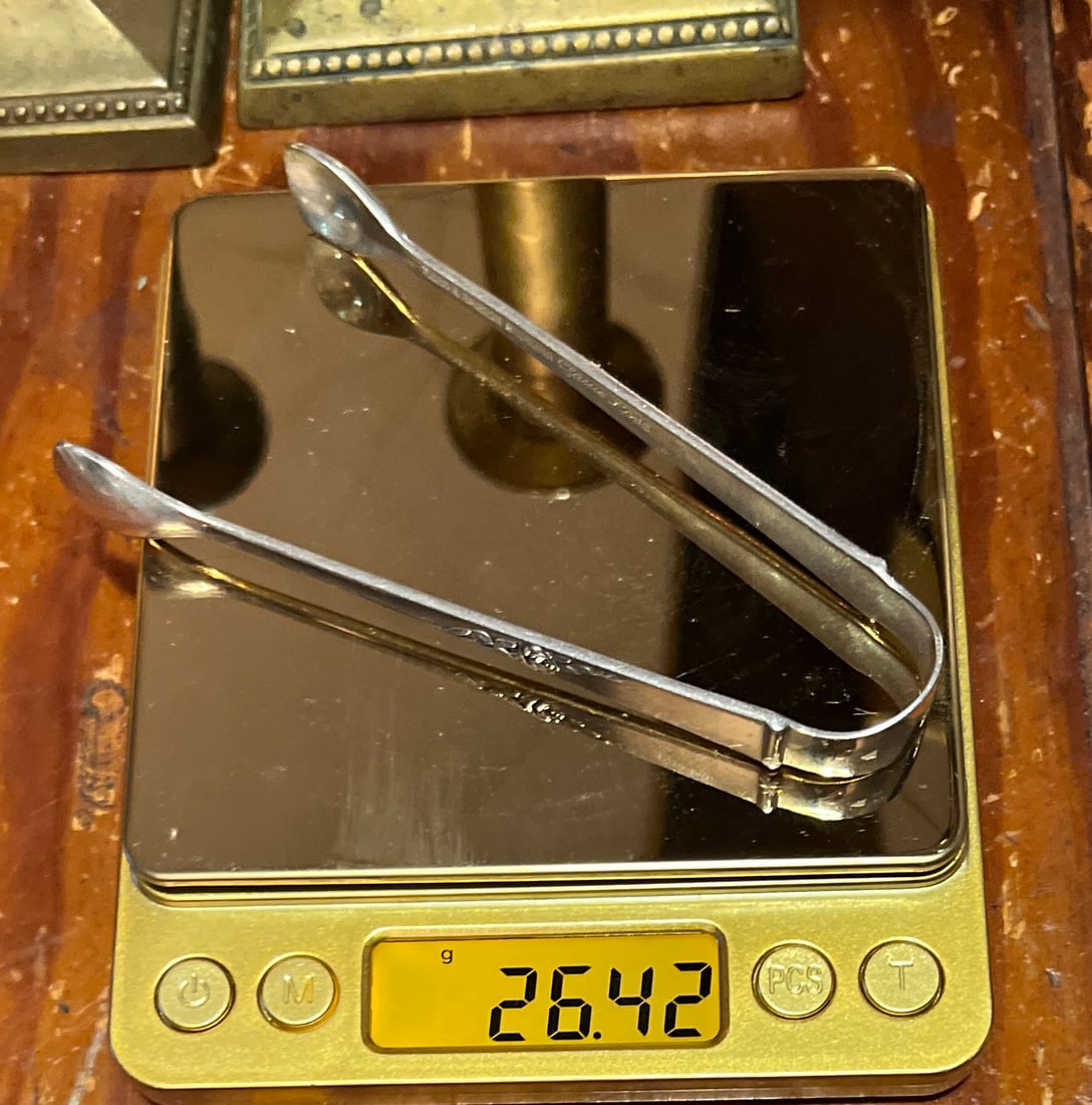 Reed and Barton Sterling Silver Tongs: Reed & Barton Sterling Silver Tongs. 1 sterling silver serving tongs. Measuring 4.25 inches long. Marked on the interior Reed & Barton Sterling Classic Rose. Rose sign on each tong handle. Tongs weigh