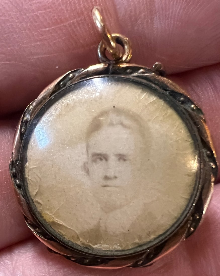 Victorian Remembrance Locket with Family Photos: Victorian Remembrance Locket. Locket measures 1 inch by 1 inch. There are three pictures, a man, a child on the back and then opens up to reveal a third picture on the inside of a woman. Likely the sa
