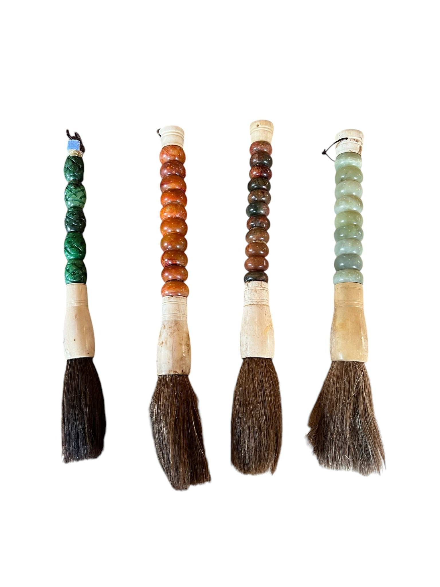 Lot of 4 Chinese Calligraphy Brushes: Lot of 4 Chinese Calligraphy Brushes. Stone handles with bone. Each measure 12 inches long. Handles appear to be made from Agate & Jade. Top of the dark green carved piece is damaged. Client 001 *****