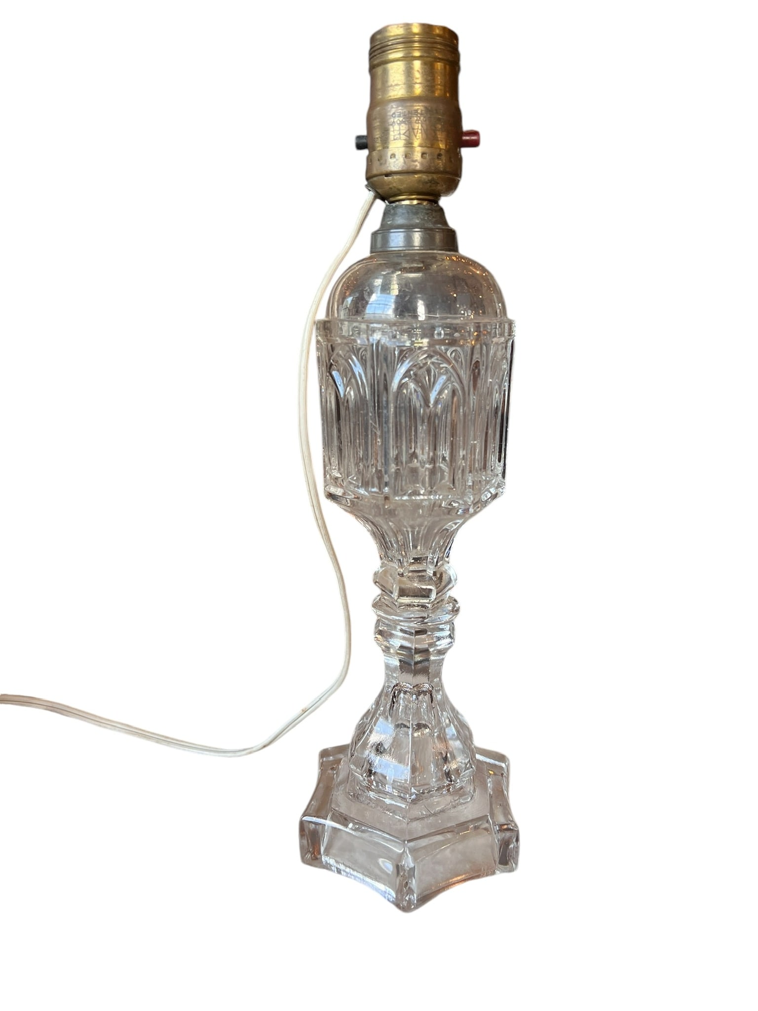 19th Century Sandwich Glass Oil Lamp Converted: 19th Century Sandwich Glass Oil Lamp Converted. Light is in working condition. Wonderful pressed Gothic Arch pattern. Measures a total of 12.5 inches tall. Good condition with some chipping at the bas