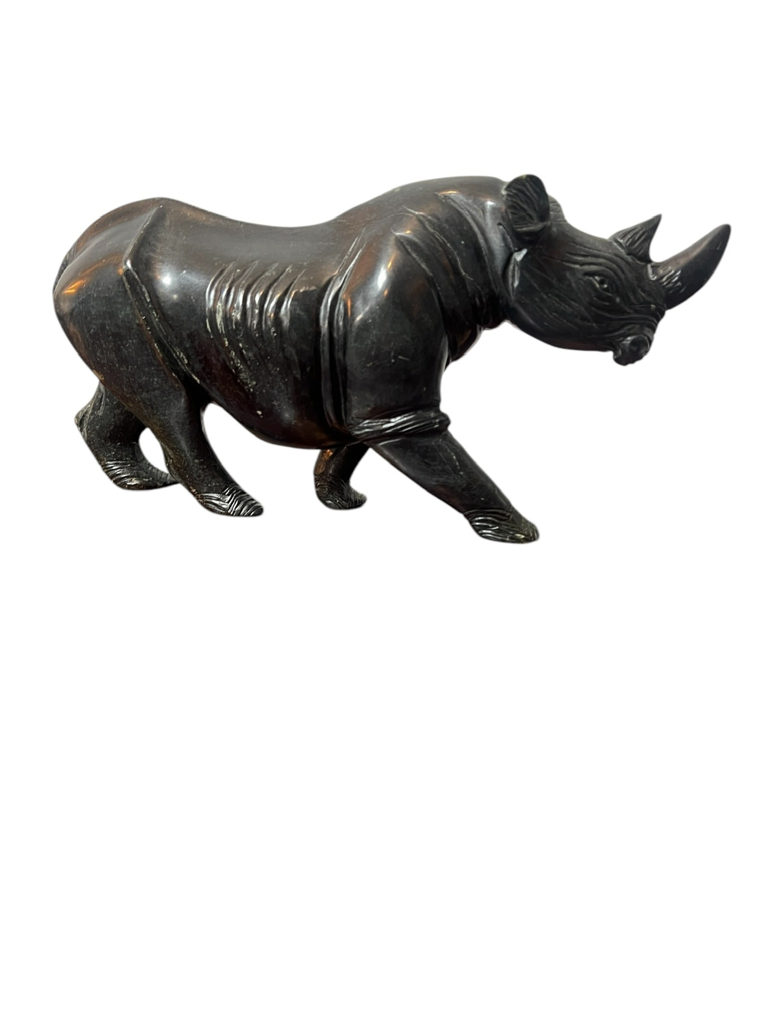 Carved Rhino Soapstone: Carved Soapstone Rhino. Nice heavy soapstone rhino measuring 11 inches long x 4.5 inches tall x 3.5 inches wide. In good condition with minor scuffs and scratches. Item obtained by Dr Astarjian during