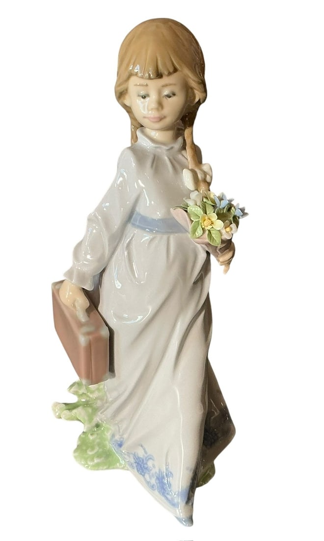 Lladro Porcelain Figure School Days 7604: Lladro Porcelain Figure School Days 7604 designed by Antonio Ramos. Designed in 1988 and retired in 1992. Not a Limited Edition. Young girl heading off to school with her school case and flowers for t