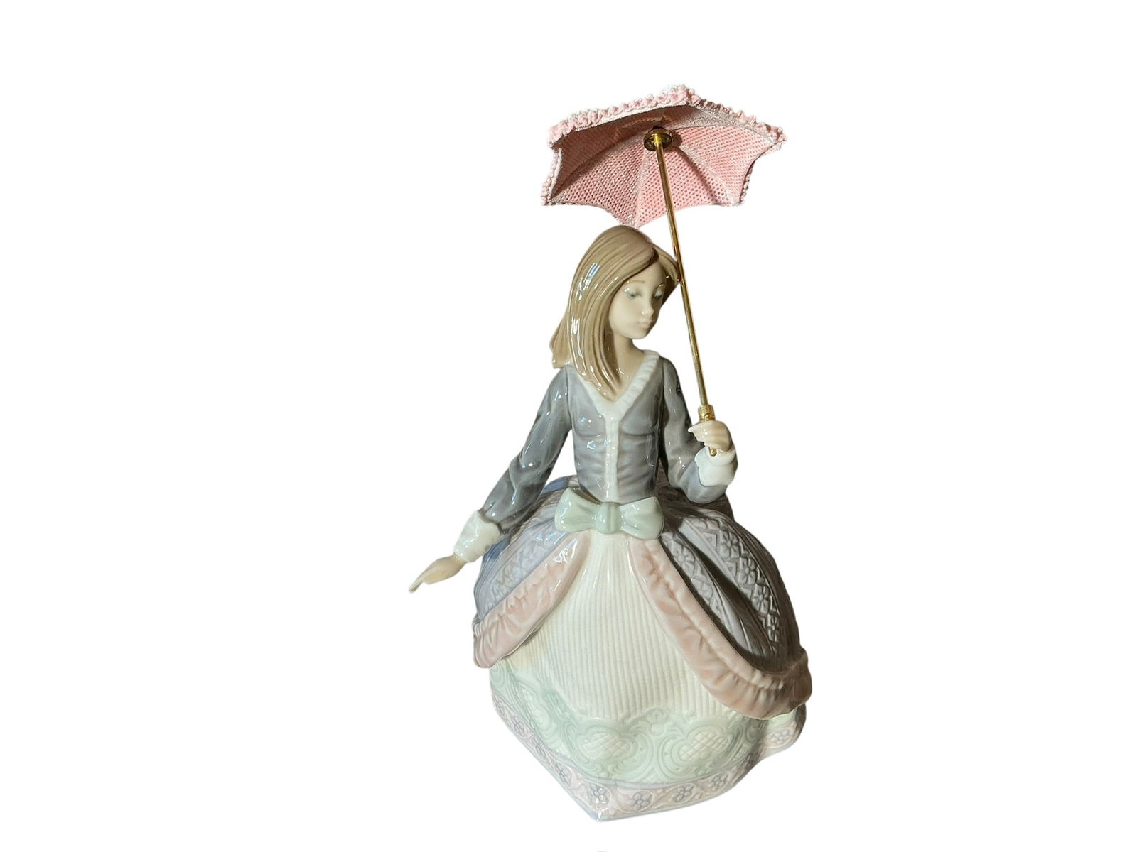 Lladro Porcelain Figure Angela 5211: Lladro Porcelain Figure Angela 5211 designed by Jose Puche. Designed in 1984 and retired in 2003. Not a Limited Edition. A young woman carrying a pink and cream umbrella. In excellent condition. Measu