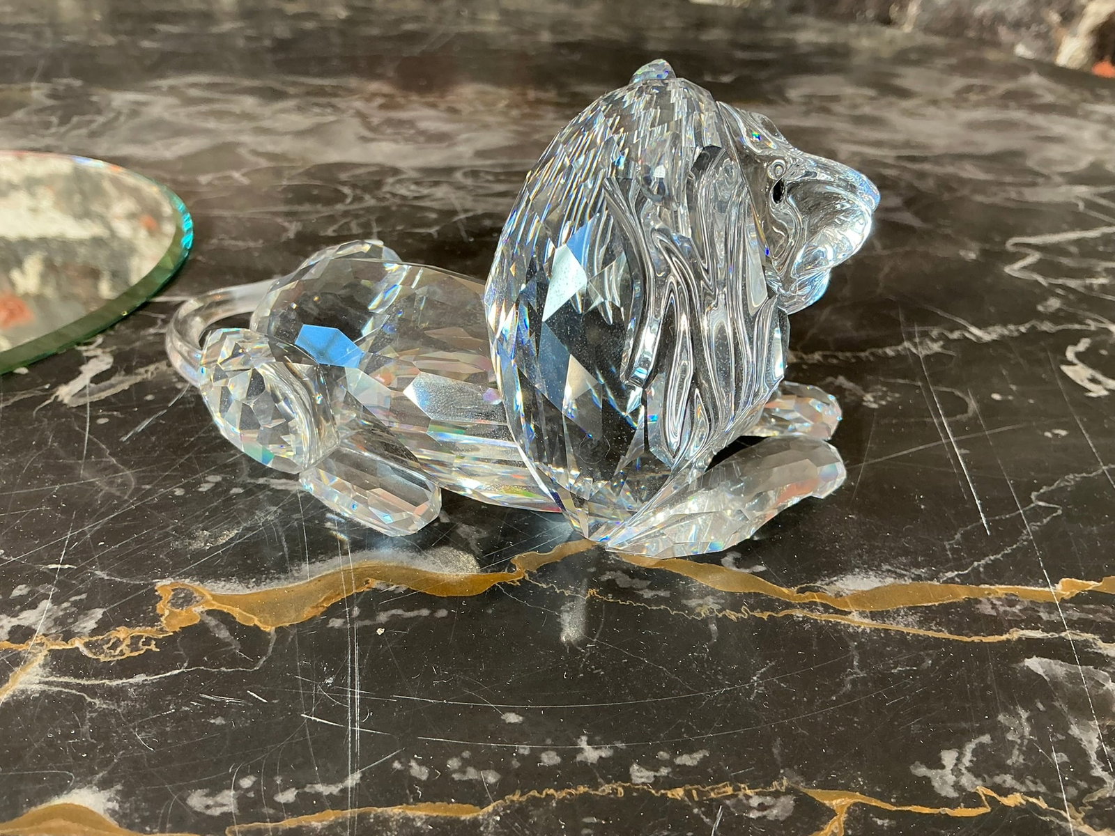 Swarovski Crystal Lion: Swarovski Crystal Lion. Inspiration Africa. Crystal figurine(s) are in very good condition and measures 3 inches x 5 inches. Introduced approx 1995. Comes with a mirrored tray. Beautiful lion with col