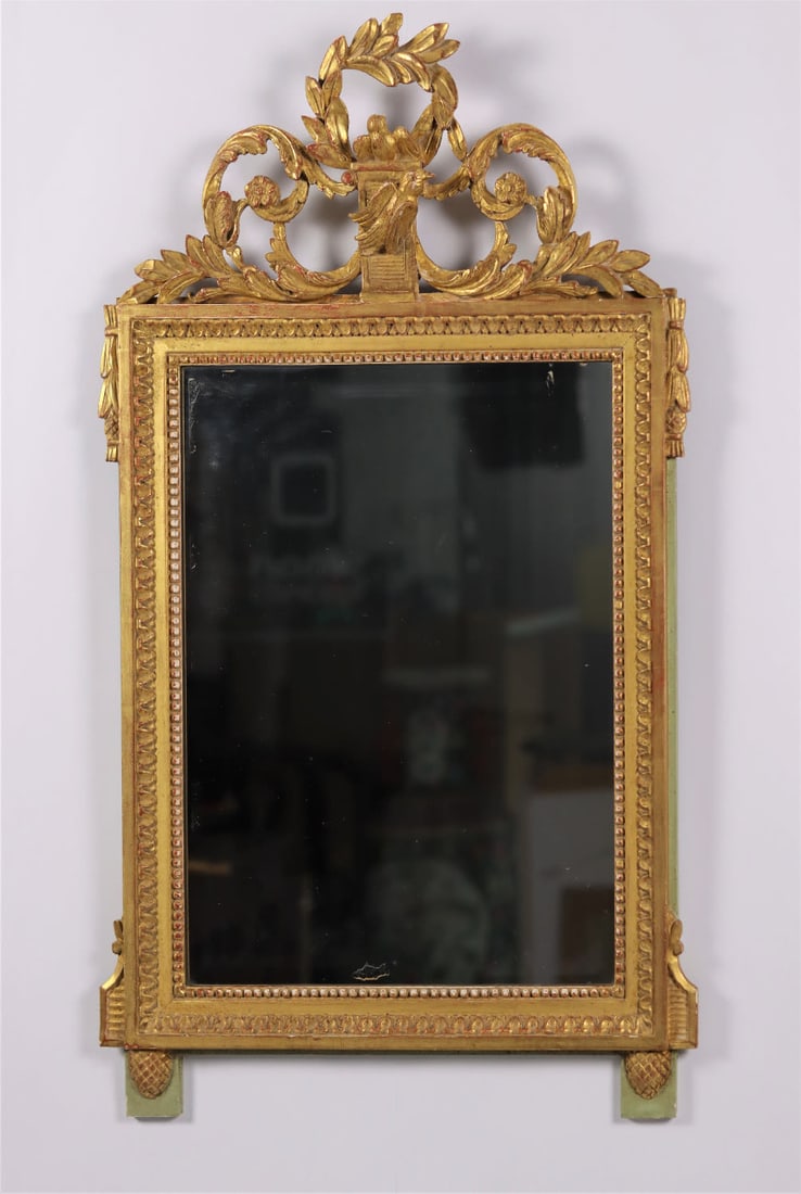 A rectangular Louis XVI-style mirror. 19th Century: Carved wood decorated with a frieze of water leaves, pearls, palmettes and rosettes and birds. The pediment is decorated with garlands of laurel, scrolls, flowers and doves. Width 55 cm height 86 cm