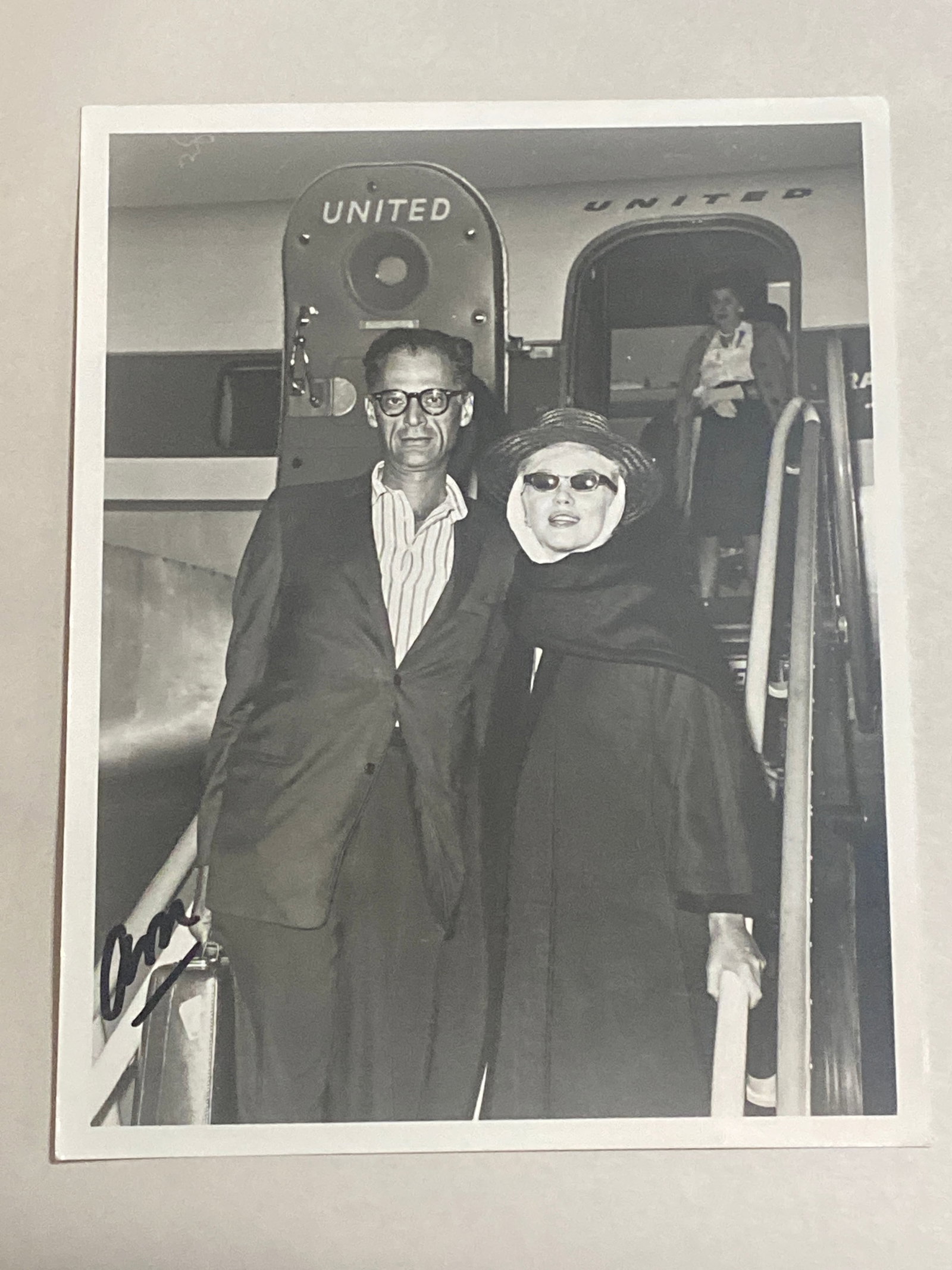 Marylyn Monroe original photograph with Arthur Miller: This auction presents an original 8 x 10 photograph of the iconic Marilyn Monroe alongside acclaimed playwright Arthur Miller. This captivating image captures a moment of intimacy and connection betwe