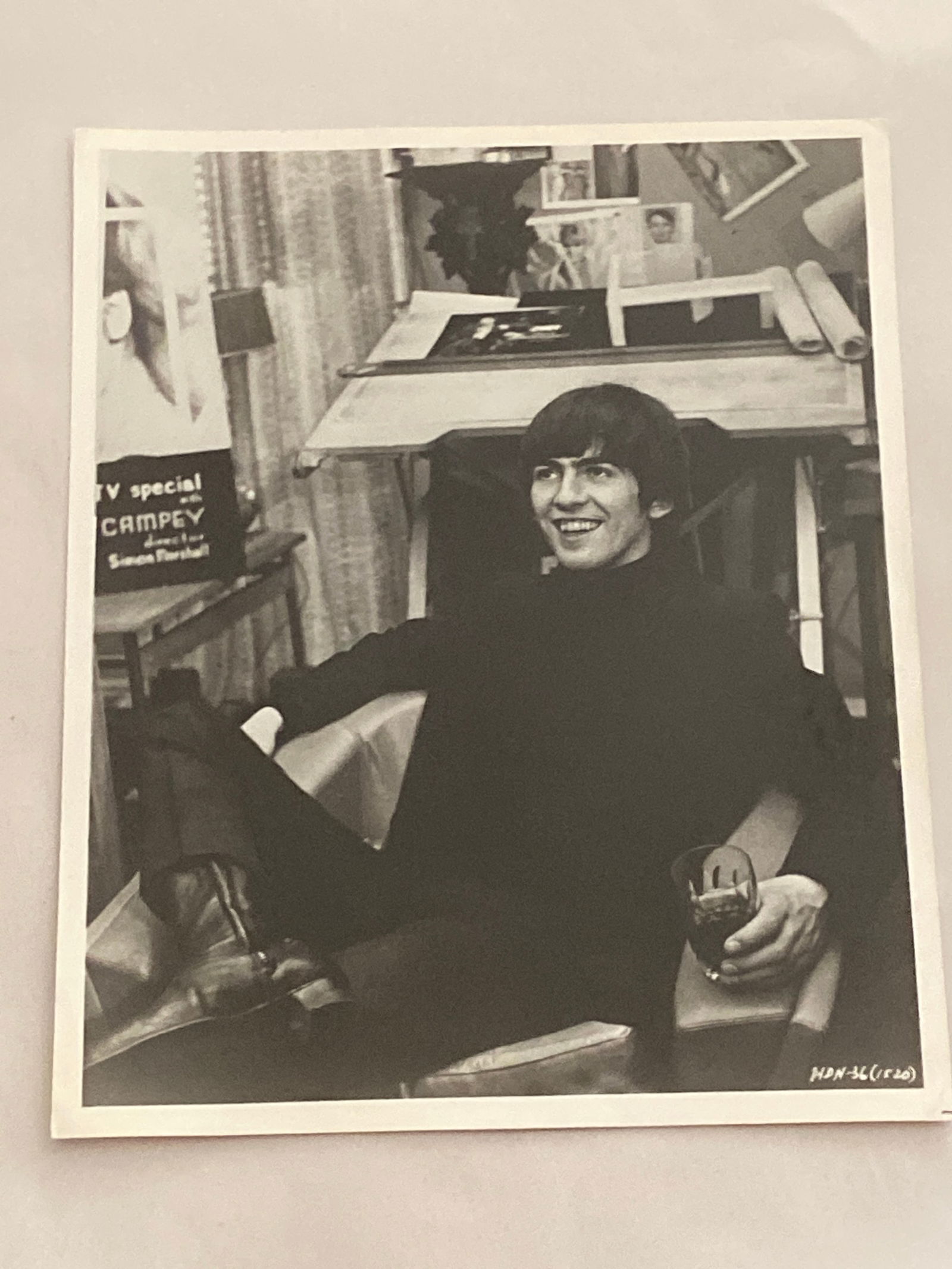 George Harrisson Original Print Beattles Photograph: This auction features an original 8x10 photograph of George Harrison, a legendary member of The Beatles. This iconic image captures Harrison in his prime, showcasing his unique style and charismatic p