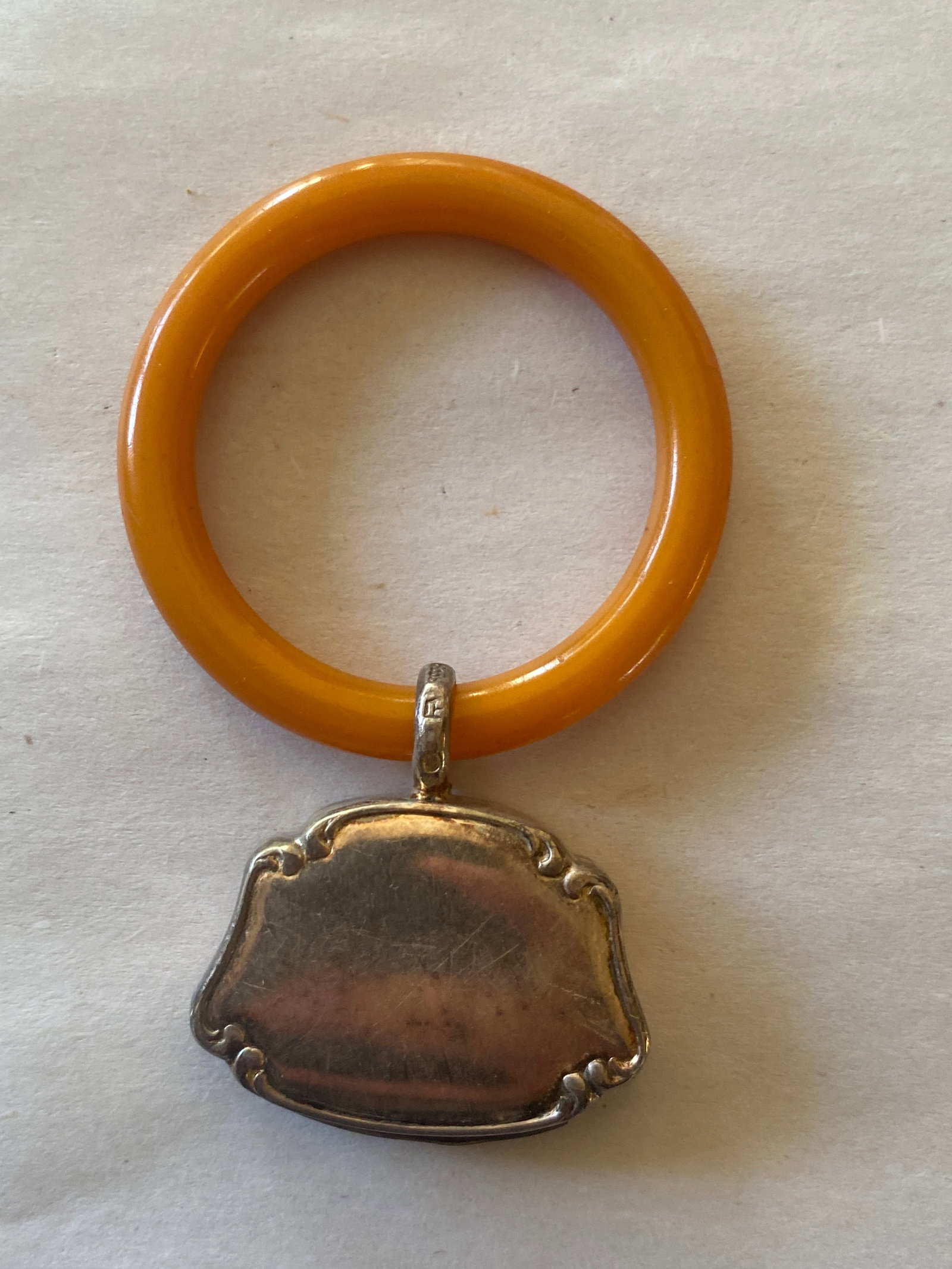 19th Century Baltic Amber Baby Rattle: This exquisite 19th-century baby rattle is a rare and precious example of Baltic amber craftsmanship. The rattle is beautifully hand-carved from rich, warm-toned amber, showcasing the natural transluc