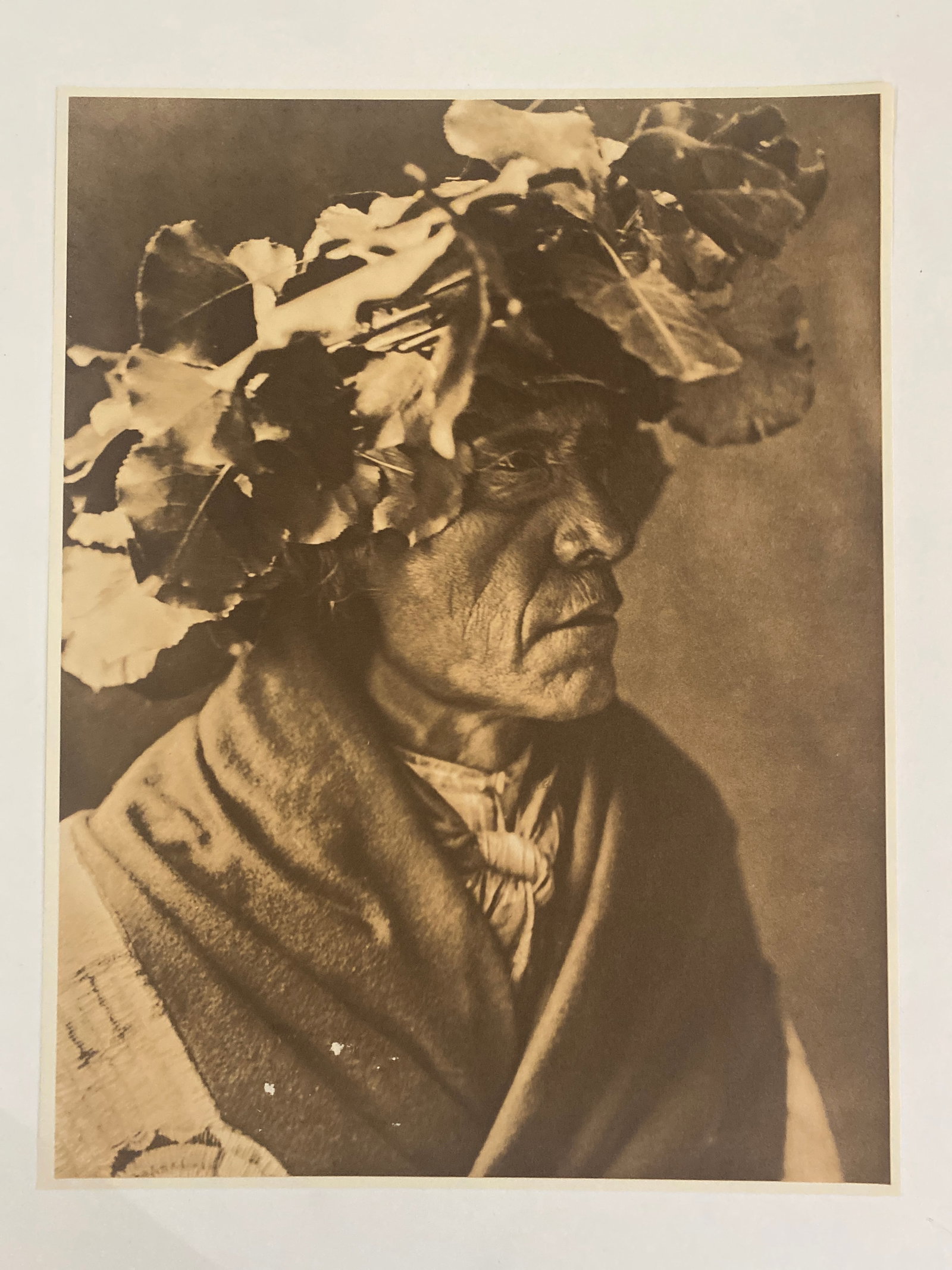 Edward S Curtis Native American Photograph: This is an photograph by renowned American photographer and ethnologist Edward S. Curtis, celebrated for his monumental work documenting Native American cultures. The lithograph features an evocative 