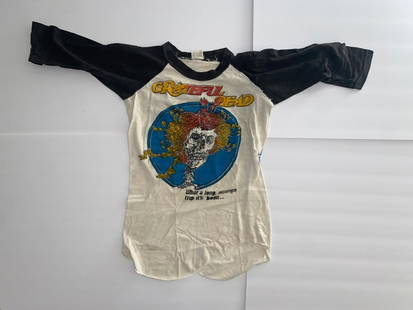 Grateful Dead 1970's US Tour T Shirt: This original 1970s Grateful Dead U.S. tour T-shirt is a vintage gem from the height of the band’s psychedelic influence. Featuring classic American tour graphics and soft, worn-in fabric, it's an a