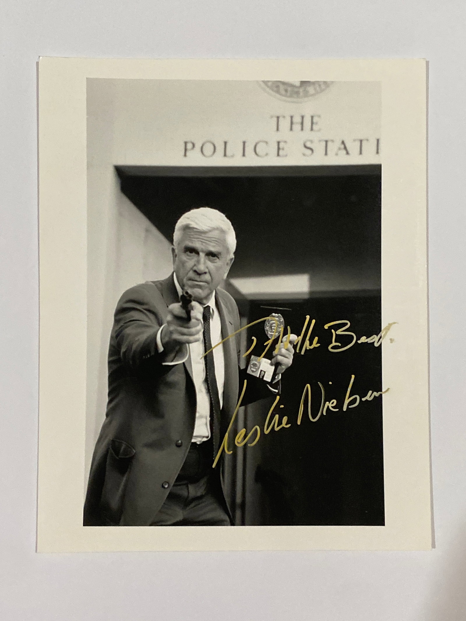 Leslie Nielson Autographed Photo: A signed 8x10 photograph of Leslie Nielsen, beloved star of Airplane! and The Naked Gun. His autograph celebrates a career that brilliantly blended comedy and charm.