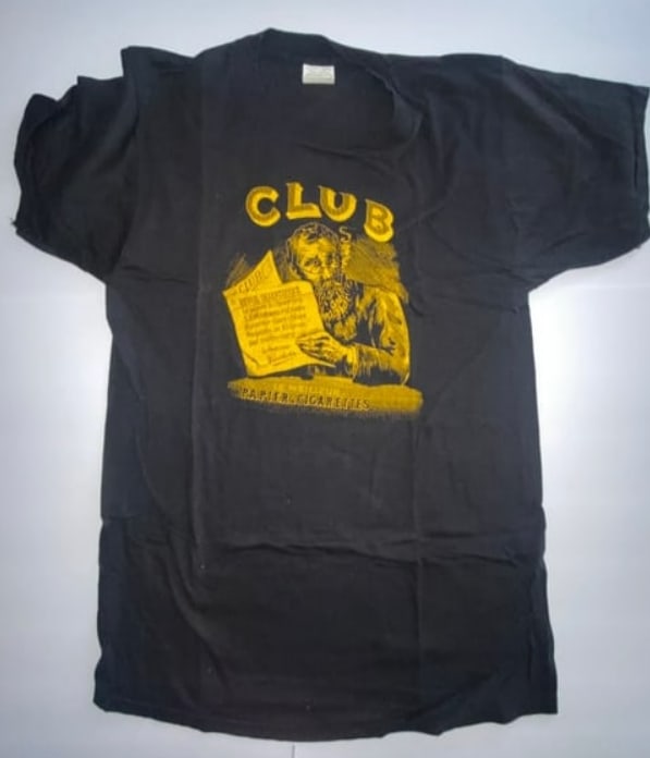 Club Rolling Papers Vintage 1990's T Shirt: A rare and playful relic from the 1990s, this Club Rolling Papers T-shirt showcases bold stoner-themed graphics in true counterculture style. Known for its irreverent humor and underground appeal, the