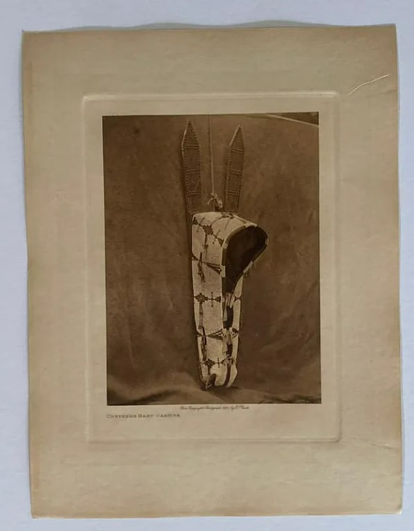 Edward Curtis 1927 Cheyenne Baby Carrier Photogravure: Part of Curtis's monumental project, The North American Indian, this photogravure highlights his signature pictorialist style—blending ethnographic documentation with fine art. The image captures th