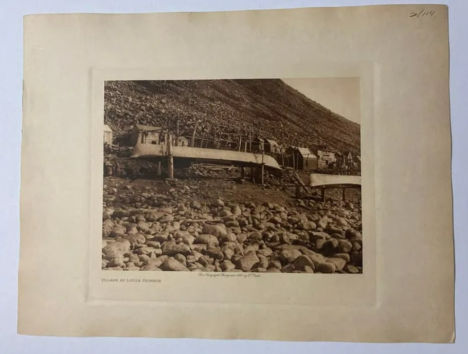 1928 Antique Edward Curtis Fish Drying Racks Photogravure: This image was captured during Curtis’s 1927 voyage to the Arctic on the power schooner Nellie Juan. It depicts the unique dwellings and skin boats (umiaks) of the Inupiat people on Little Diomede I