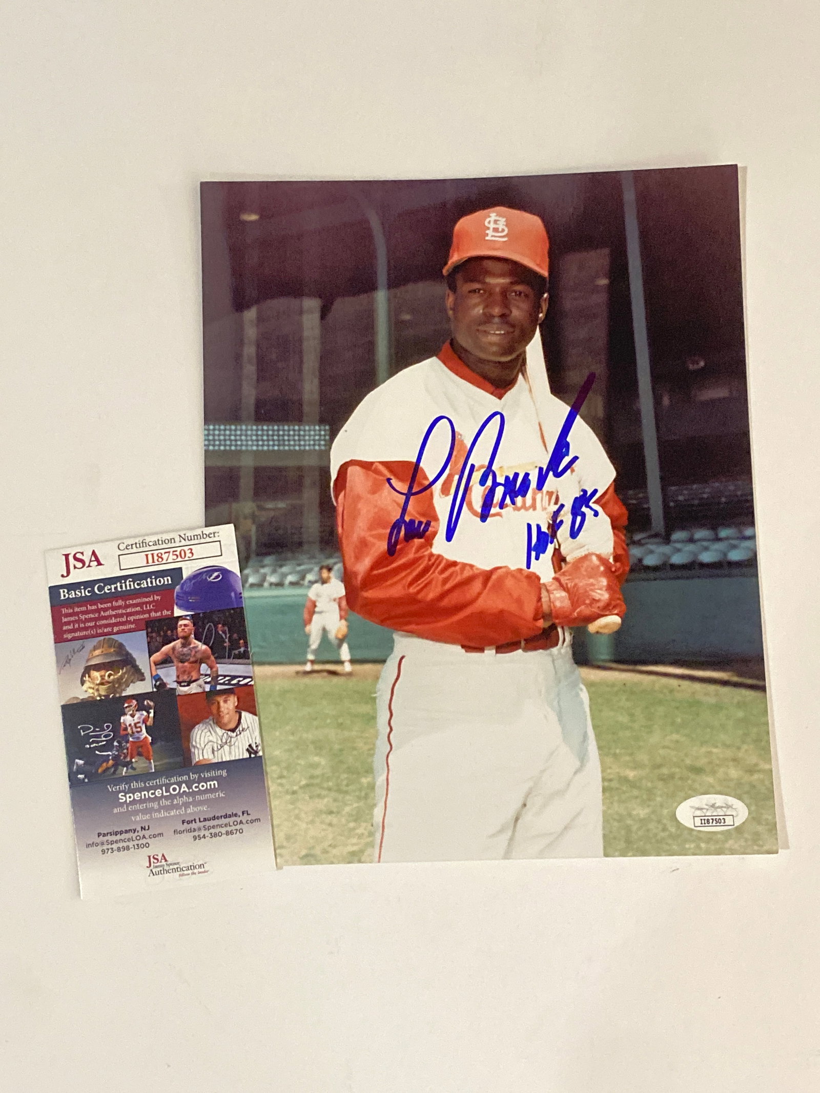 Lou Brock Autographed Photo JSA: Signed photograph of Lou Brock authenticated by JSA, honoring the legendary St. Louis Cardinals base-stealing champion and Hall of Fame player, presented as a desirable piece of vintage baseball