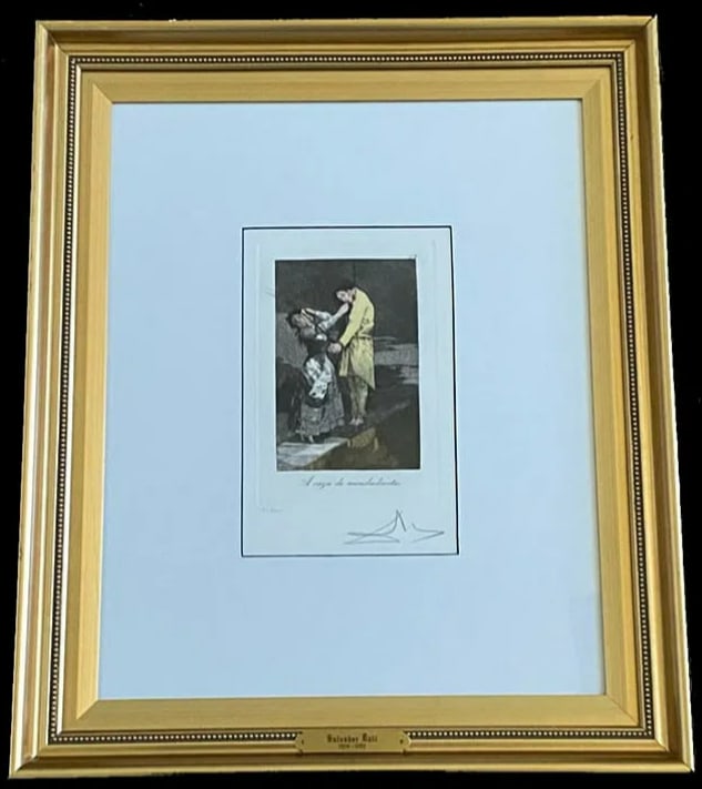 Salvador Dali Hand Signed A Caza De Mondientes Print 37/200 COA: This hand-signed print by Salvador Dalí is a numbered edition (37/200) that showcases his surrealist reimagining of Goya’s work. The piece features Dalí’s trademark warped perspectives and