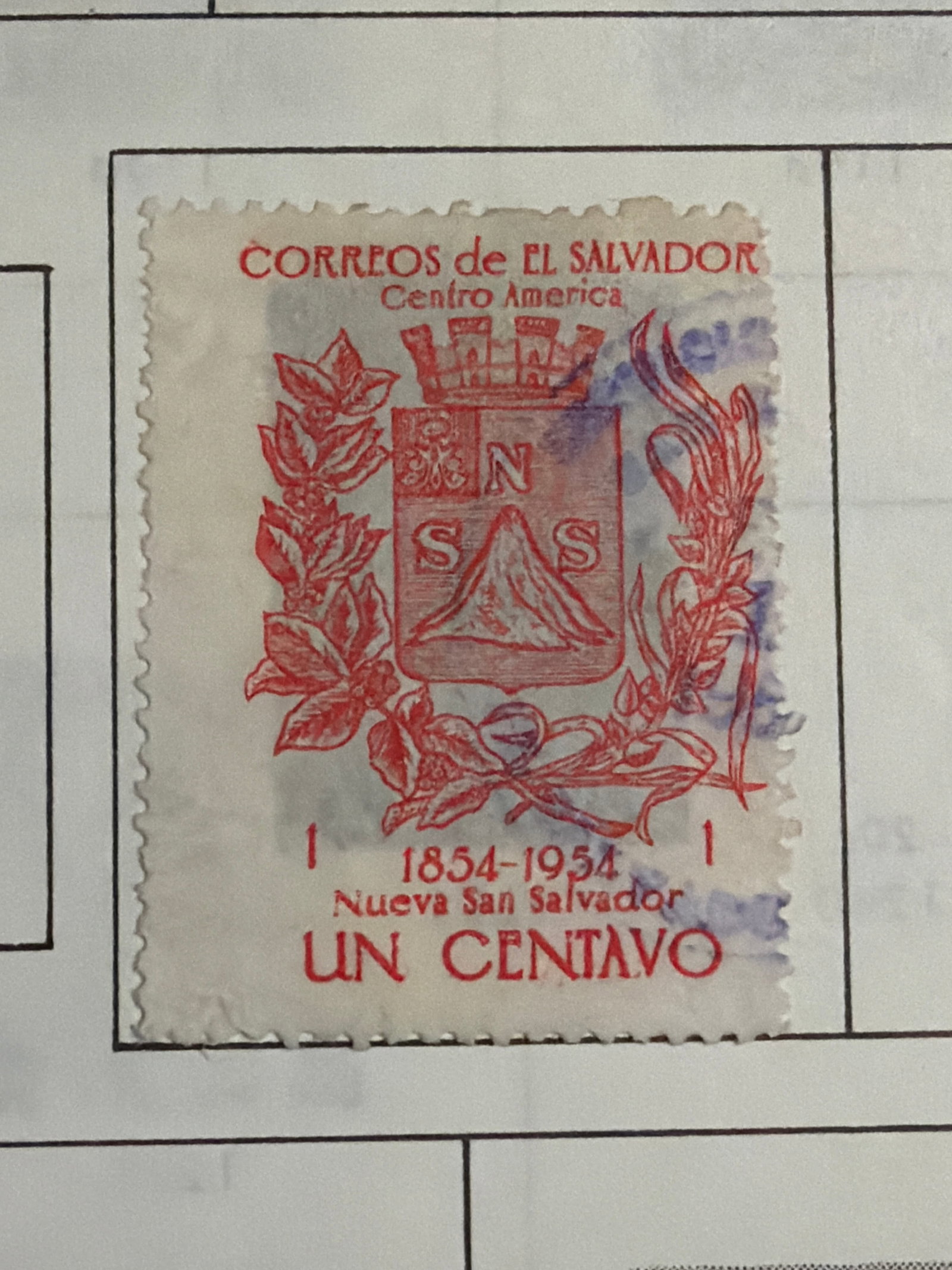 1954 El Salvador Nueva San Salvador Centennial 1c Stamp: Single El Salvador 1-centavo commemorative marking the centennial of Nueva San Salvador, dated 1854-1954. The red heraldic design features the city?s coat of arms surrounded by decorative foliage,